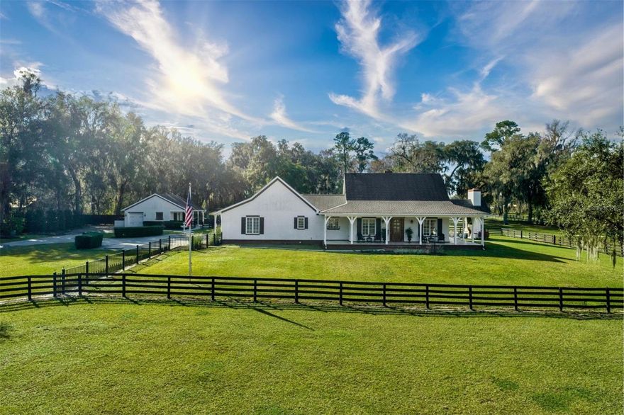 Welcome to an extraordinary equestrian estate nestled in the heart of South West Ocala, a short distance from the esteemed World Equestrian Center. This remarkable property, situated on a tranquil 10 acres epitomizes the pinnacle of luxury living for both horse enthusiasts and those seeking an exquisite country retreat. As you approach the gated entrance, the sweeping driveway leads you to a masterfully crafted residence that must be seen to be fully appreciated. The main home, boasting 3 bedrooms and 2.5 baths, is a testament to superior craftsmanship and quality construction. Step inside to discover the timeless elegance of oak flooring, the regal touch of crown molding, and the focal point of a woodburning fireplace adorned with hand-carved European limestone. The cathedral ceiling, adorned with exposed beams, adds an extra layer of grandeur to the living space. For those with a penchant for culinary delights, the top-notch kitchen beckons with extensive cabinetry and high-end appliances. The sunlit adjoining sunroom, seamlessly connected to the dining area, extends into a meticulously designed pool and summer kitchen area, showcasing thoughtful attention to detail and careful planning, thereby creating an ideal setting for gatherings and celebrations. Just steps away, an additional living space awaits, designed to complement the main residence in both style and substance. Boasting over 700 square feet, this versatile bungalow is perfect for a mother-in-law suite, a home office, or even a private gym. The attention to detail and commitment to excellence are evident in every corner of this auxiliary dwelling. Retreat to the roomy master bedroom, where luxury meets functionality. The en-suite bath is a haven of relaxation, featuring dual vanities, marble counters, and custom cabinetry, all complemented by a generously sized walk-in closet. Beyond the confines of the home, the property stands ready to accommodate your equine companions. Fully fenced, it includes a well-appointed 2-stall barn with a tack room, providing a comfortable haven for your horses. A detached garage with a workshop further enhances the functionality of the estate. This equestrian estate in South West Ocala is a rare gem that combines sophisticated living, exceptional craftsmanship, and equestrian amenities in a picturesque setting. With too many outstanding features to list, this property is a must-see for discerning buyers. Schedule your appointment now, as opportunities like this don't linger in the market for long. Seize the chance to make this extraordinary estate your own, where luxury living and equestrian pursuits harmoniously converge.