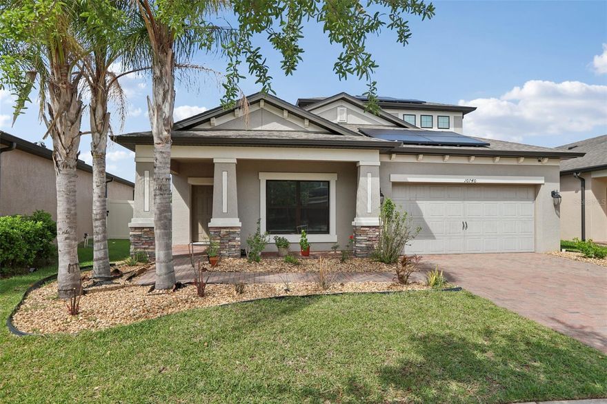 One or more photo(s) has been virtually staged. Nestled within the exclusive gated enclave of Winsome Manor at K-Bar Ranch, this lovingly maintained 2,966 sq. ft. residence offers a sophisticated blend of luxury, sustainability, and peace of mind. At the center of the home is a chef-inspired kitchen featuring gleaming quartz countertops, 42” cabinetry, double ovens, and a brand-new appliance suite—all overlooking an airy family room adorned with contemporary wood-look tile. The versatile split-level layout includes a massive main-floor primary retreat and a secluded upper-level guest suite with a bonus room, wet bar, and wine refrigerator. Beyond the fresh interior paint and dedicated home office, this home is engineered for resilience and efficiency with hurricane impact-resistant windows and doors and 26 solar panels that significantly reduce energy costs. Step outside to the extended, screened lanai with fresh epoxy flooring to enjoy breathtaking, unobstructed sunset views over the serene pond and conservation area. Roof & A/C new in 2018. Perfectly situated in the New Tampa/Wesley Chapel corridor, you are minutes from premier dining, top-tier medical facilities, and quick commutes to USF or downtown Tampa.