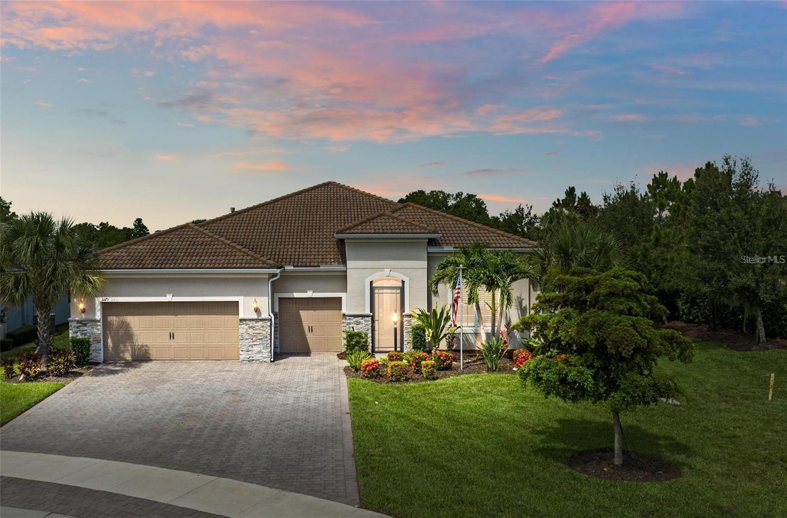 One or more photo(s) has been virtually staged. Where timeless elegance meets modern Florida living—welcome to your dream home in Mallory Park. This luxurious 2,900-square-foot residence, built in 2018, embodies modern elegance and functional comfort.
Seamlessly blending opulence with practicality, the home features an impressive Great Room with 10-foot tray ceilings, zero-corner sliding glass doors that expand the living space outdoors, and a custom-built media center designed for top-tier entertainment. The chef’s kitchen is a culinary masterpiece, outfitted with modern appliances, a spacious pantry, and elegant Pottery Barn lighting above the expansive island.
Adjacent, the dining area dazzles with a new Pottery Barn chandelier and direct access to the outdoor oasis through zero-corner sliding glass doors. The Primary Suite offers a private sanctuary, a spacious bedroom with a large walk-in closet featuring a built-in organization system, and an en-suite bath complete with double vanities, a soaking tub, and a separate shower.
Additional generously sized bedrooms share a convenient Jack-and-Jill bathroom. Architectural details abound throughout the home, from high ceilings to tray ceilings, creating an atmosphere of refinement and luxury.
Practical features include a large laundry room with additional appliances, a three-car garage with ample storage solutions, and a custom-built drop zone for daily organization.
Outdoors, the home continues to impress with a newly heated pool, a screened lanai with new bug protection screens and privacy panels, two spacious covered patio areas ideal for dining and gatherings, and a sunny deck perfect for enjoying the Florida sunshine. A fully fenced yard ensures pet safety, while the property’s prominent corner lot location offers privacy and scenic views.
Residents of Mallory Park enjoy exclusive access to a gated community entrance, proximity to top-rated schools, and a variety of amenities, including a state-of-the-art amenity center with clubhouse, gym, resort-style pool, event space, gathering areas, fishing lake with dock, fire pit area, and playground.
Located in the heart of Lakewood Ranch, residents have easy access to shopping centers, medical facilities, dining options, and recreational activities. With its unbeatable location and exceptional features, this home presents a rare opportunity to live in luxury in Lakewood Ranch. Contact us today to schedule your private tour and experience elegant Florida living.