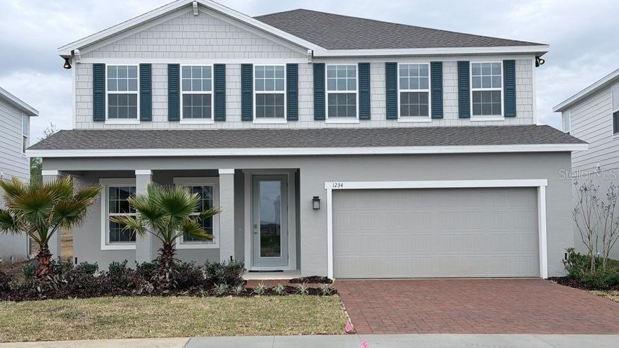 One or more photo(s) has been virtually staged. Welcome to 1234 Whispering Lane in the highly desirable Overlook at Grassy Lake community in Minneola. This former builder model, never occupied, features 5 bedrooms, 3 bathrooms, and over 3,000 square feet of thoughtfully designed living space. Built with over $85,000 in premium upgrades, the home showcases refined stucco veneer exterior and enhanced curb appeal. Inside, the open concept layout connects living, dining, and kitchen areas seamlessly, with designer cabinetry with crown molding and under cabinet lighting, upgraded finishes, and a full stainless appliance suite including cooktop, double ovens, microwave, and french door refrigerator. Smart home features such as a WiFi thermostat and garage opener add everyday convenience, while flexible living spaces allow for a home office, additional lounge, or guest needs.

Outdoor living is elevated with an extended covered lanai and an oversized backyard offering ample room for a pool, spa, fire pit, or garden. Residents of Overlook at Grassy Lake enjoy resort-style amenities including a pool, cabana, green spaces, and playground, along with the benefit of no CDD and a low monthly HOA. The location offers exceptional accessibility, just one mile from the Florida Turnpike, less than five minutes to shopping and dining, and close to outdoor recreation at Minneola Athletic Complex and Lake Hiawatha Preserve. Zoned for top-rated schools within two miles and surrounded by major upcoming development including a new hospital, retail, and infrastructure improvements, this 5-bed home in Minneola presents a rare opportunity to own a move-in-ready model home in a rapidly growing area.