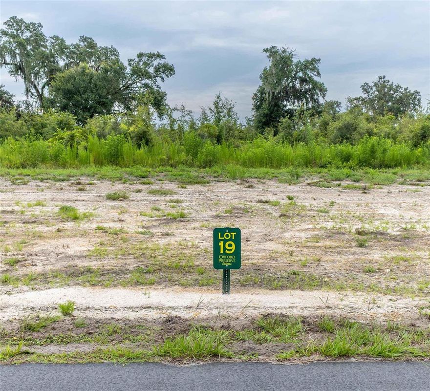 Experience luxury living infused with county charm in the exclusive, privately gated community of Oxford Preserve Estates.  With only 20 estate lots set on 5-8+ acre parcels of land, each is unique featuring pristine, wooded land highlighted by majestic native Live Oaks, graceful palmetto, and scrub oaks. Designed with both elegance and natural beauty in mind, all utilities are discreetly placed underground, preserving the serene landscape while offering modern convenience. There is no set timeframe for building your custom dream home, giving you the freedom to choose your own builder and craft a residence that perfectly suits your lifestyle. Public utilities are robust and reliable, including high-speed Spectrum internet and dependable SECO electric service, while private utilities such as well and septic systems are managed individually by each lot owner. Home designs are thoughtfully mandated to ensure spacious living, with one-story homes requiring a minimum of 2,400 square feet and two-story homes needing at least 1,800 square feet on the first floor. Adding to the appeal is an affordable HOA yearly assessment of less than $800, which helps maintain the community’s pristine condition. Ideally located, this neighborhood offers true Florida living at its finest, with the convenience of being less than a 10-minute drive from essential amenities including The Villages Charter School, Super Walmart, Publix, Costco, Chick-Fil-A, Lake Sumter Landing, Home Depot, Lowes, and churches.