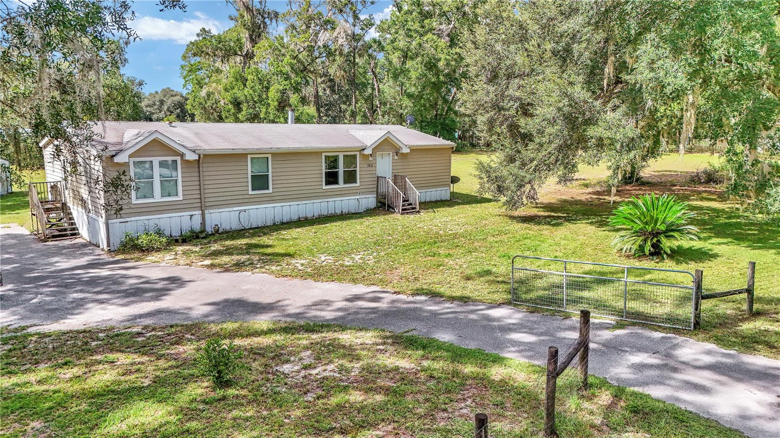 Imagine coming home to your own fully fenced acre with gated entry, where space, privacy, and comfort all come together. This 2006 home offers over 1,800 sq. ft. with a split floor plan, making it perfect for both quiet evenings and lively gatherings. Concession for new roof will be given with an acceptable offer!! The heart of the home is the huge kitchen island, designed for more than just cooking. Pull up a chair for morning coffee, spread out the snacks for game night or let the kids do homework while dinner is simmering. With abundant cabinets and storage, everything has its place. Unwind in the master suite, your personal retreat with dual sinks, a private office, a walk-in closet, and a soothing jet tub made for long, relaxing soaks. Two additional bedrooms give everyone their own space while keeping the flow of the home open and inviting. Step outside to the covered, screen-enclosed back porch, where you can watch the sunrise, listen to the rain, or host weekend barbecues. The yard is ready for pets, play, gardening, or simply enjoying the peace of country living. A short 15 minute drive to Crystal River where you will find shopping, restaurants, grocery stores, medical offices, hiking trails and many options for water activities!