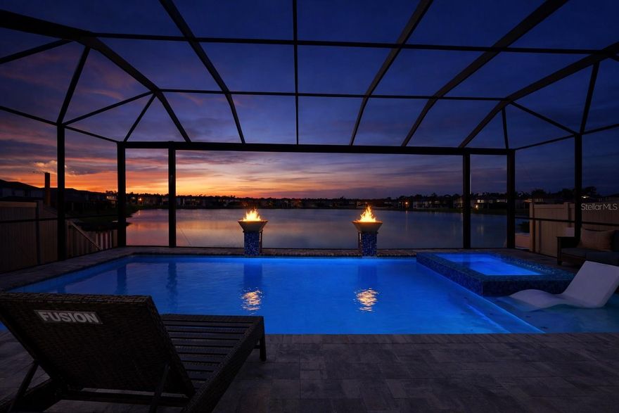 Experience refined Florida living in this stunning, fully upgraded 5-bedroom, 4-bathroom residence located in the desirable Berry Bay community. Built in 2023 and meticulously enhanced, this expansive 3,566 sq ft home offers a perfect blend of modern elegance, comfort, and breathtaking lakefront views.
From the moment you enter, you are welcomed by soaring ceilings, rich architectural details, and a light-filled open-concept design. Elegant wood and tile flooring flow throughout the main living spaces, complemented by crown molding and designer finishes that create a sophisticated yet inviting atmosphere. The gourmet kitchen seamlessly connects to the living and dining areas, making it ideal for both intimate gatherings and large-scale entertaining.
The upper level features a luxurious primary suite designed as a private retreat, complete with a spacious walk-in closet and serene ambiance. Additional bedrooms provide ample space for guests, family, or a dedicated home office.
Step outside to your private resort-style backyard—a rare feature in Berry Bay, as most homes do not offer private pools. Enjoy your heated pool overlooking tranquil lake views, creating the perfect setting for sunset evenings and year-round enjoyment. The outdoor kitchen further elevates the space, offering a seamless indoor-outdoor lifestyle ideal for entertaining.
This exceptional home also includes a two-car attached garage, a beautifully landscaped private yard, and an abundance of natural light throughout. Residents of Berry Bay enjoy low HOA fees and access to premier community amenities including a clubhouse, park, playground, and dog park.
Combining luxury finishes, expansive living spaces, and exclusive outdoor living, this home presents a rare opportunity to own one of the few pool homes with lake views in this sought-after community. (Buyer to verify all  dimensions and sf are approximate )