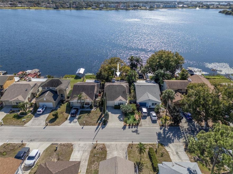 Welcome to this beautiful, move-in-ready 2-bedroom, 2-bathroom lakefront home offering 1,186 square feet of comfortable living space in Winter Haven's most desirable waterfront community on pristine natural freshwater Lake Dexter. This charming residence features a newer roof and HVAC system, fresh ceramic tile flooring throughout the living areas, a cozy wood-burning fireplace, and mature landscaping with lemon and banana trees that thrive in Florida's tropical climate. The property includes a private covered boat dock with a recently redecked platform (within the past 4 years) and hurricane protection wood panels with pegs for all windows. Enjoy direct lake access to Lake Dexter, ideal for boating, fishing, and water sports, along with exceptional community amenities including a private residents-only boat ramp, sparkling saltwater community pool, and a serene waterfront park complete with fishing dock, gazebo, playground, and shaded picnic areas. Located in a quiet, established neighborhood just minutes from LEGOLAND Florida Resort and approximately one hour from both Orlando and Tampa, this turnkey lakefront property offers the perfect Florida lifestyle, combining lakeside living with convenient access to Central Florida's top attractions.