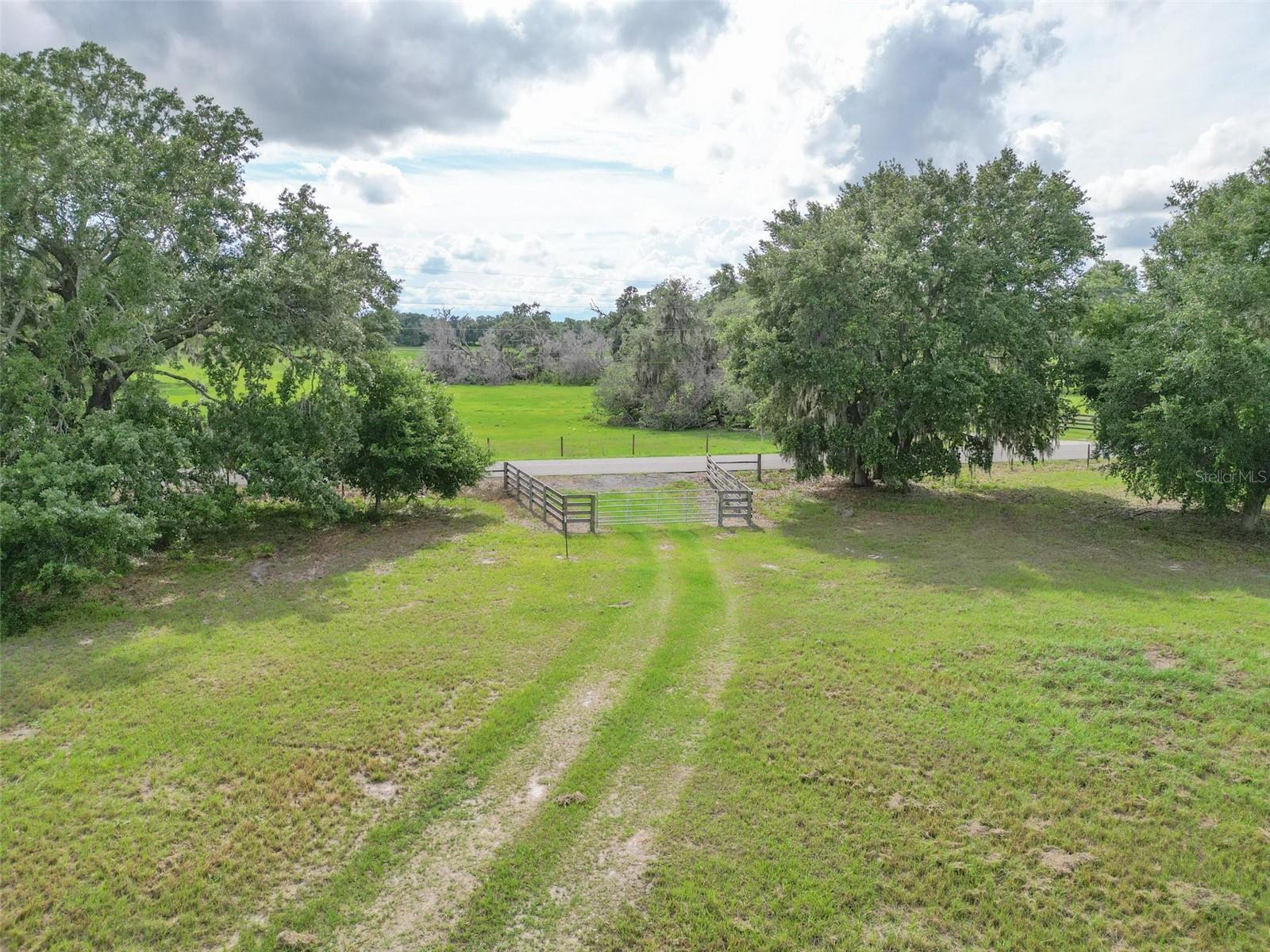 In a community where land still matters and working with your hands is a way of life for more than just a few, this 12.45-acre homesteader’s dream in Webster, Florida delivers the rare kind of freedom that’s getting harder to find.
Set along a paved county road in Sumter County, this property is the ideal canvas for your dream build—whether you’re raising animals, growing crops, or just want a place to plant your roots (literally and figuratively). Located just 1± mile from Hwy 50, you’ll have easy access to I-75 and the Turnpike, yet you’re surrounded by open pastures, legacy oaks, baby oaks, and a landscape shaped by generations of stewards.
No HOA. No Deed Restrictions. Just Possibility.
The land is high and dry with gentle roll, perfect for that sunrise-facing porch or wraparound farmhouse you’ve always imagined. We think the elevation in some areas tops 95 feet. The fencing is already in place, and the property is currently in hay production, making it ideal for ag exemptions or continuing the operation.
Two 200-amp service panels and underground electric are installed. There are two wells already onsite. The standout 20x40 metal-roofed workshop is fully powered, with a concrete slab, electric roll-up door —perfect for building, restoring, or storing the tools of your trade. Inside, it’s spacious, clean, and thoughtfully built for real use.
Legacy Starts Here
The seller recently planted nineteen live oaks across the property—trees that will grow alongside your story, adding character and permanence to your homestead.
You can feel the soul of this land when you stand under the oak canopy or walk the cleared pasture trail. The parcel sits among other rural homesteads, yet offers plenty of elbow room. It’s a place for some chickens and some cows, for sunrise coffees and sunset bonfires.
Easy access to shopping, medical care, and dining, you’ll get the best of both worlds—rural Florida charm with real-world convenience. One hour to Tampa International Airport or Orlando International Airport. Less than 30 minutes to The Villages.
This is more than just a parcel. It’s a place where you build your story—by hand, by heart, and by the acre.
Shown by appointment only. Let’s go walk it together—you’ll know if it’s yours the moment your boots hit the ground.