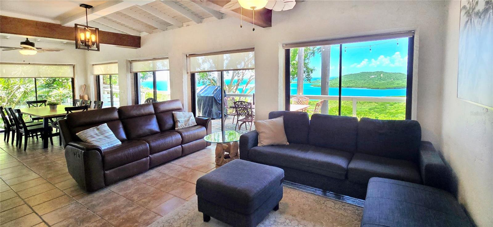 Discover the ultimate Caribbean escape on this breathtaking 5-acre property, where indoor-outdoor living reaches new heights. This extraordinary estate features two distinct homes designed to embrace the island lifestyle, with every room offering ocean views. The two thoughtfully designed homes provide flexibility for extended family, guests, or rental income potential, each capturing the essence of Caribbean with modern comfort. This property was designed for those who live for the outdoors. Multiple decks create intimate spaces for dining, lounging, and entertaining while maximizing those incredible water views. Both houses have appointed outdoor showers, where privacy meets the invigorating sensation of showering al fresco. Exclusive access to a private 120 ft community dock lets you enjoy fishing, snorkeling, paddleboarding, and boating adventures. This property can be your island retreat, multi-generational living, vacation rental investment, or your permanent Caribbean residence.