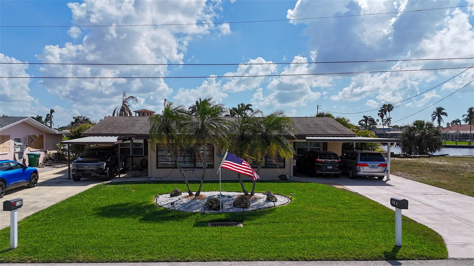 Location, Location, Water view! Currently room for two boats 38 feet or longer. One lift kept and one in the water at the pier. More dockage could be added. This extremely well maintained duplex has an absolutely stunning South, Southwest view looking out over a 200 foot canal. The gulf access in Cape Coral doesn’t get better than this. Approx. 10 minutes idle to the river and 5 miles to open water! Spend your days relaxing on the almost 1,000 sq ft covered back porches. Each unit has an under-truss bonus room added in the front that is under air and boasts an additional 320 sq ft. The structure and landscaping has been meticulously maintained by the owner occupants. New roof placed in 2012, New A/C on right unit in 2018, left unit 2009. All new tile floors, new bathrooms and kitchens. Come see this piece of paradise that is primed to be a timeless investment located just down from the Bimini Basin and Four Freedoms park. An investor could collect rent on both sides or live in one, rent the other, and park two or more 38 foot plus cigarette or large center consoles It is a must see in person. Covered parking for up to 4 vehicles.