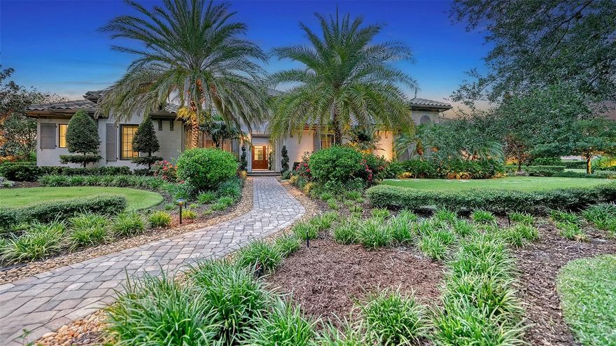 Welcome to this stunning custom-built estate by Anchor Builders, located on a spacious 3/4 acre homesite in the exclusive Concession community. Majestically set among mature, manicured landscaping that overlooks breathtaking views of the picturesque lake and private preserve, this California-style courtyard designed home is perfect for entertaining and enjoying luxurious living. Step through the grand Mahogany front door into the main family room, where you'll find a coffered wood ceiling, a stone surround gas fireplace, and elegant custom built-ins. Entertain guests at the built-in bar and store your finest wines in the temperature-controlled wine room. The living area's sliders disappear, blending seamlessly with the screened covered lanai that features an additional fireplace and wood beam ceiling details. The chef's kitchen is a dream come true, boasting Thermador appliances, a leathered granite island, ample upgraded cabinetry, a 6-burner plus griddle gas cooktop and custom hood, built-in double ovens, 2 refrigerator drawers, decorative tile backsplash, wood beams in ceiling, a baker's pantry and walk-in pantry. The formal dining room, highlighted by a tray ceiling, opens to a secondary courtyard with fountain through French doors. The kitchen breakfast area features two sets of French doors, one set opening to the lanai and the other to an outdoor covered kitchen area, complete with a sink, Lynx grill, refrigerator, and exterior pool bath. Relax in the large heated pool and spa surrounded by travertine while enjoying unobstructed views of the lake and preserve, offering complete privacy within the gated backyard's lush landscaping and serene setting. The primary suite is an oasis of luxury, featuring a gas fireplace, tray ceiling, crown molding, French door entry to the courtyard, disappearing sliders to the pool and lanai, remote blinds, a private office with built-in desk and cabinetry, large his-and-her walk-in closets with custom cabinetry, and a spa-like bath with marble flooring and counters. The main house also includes an office/den with wood floors and a wall of custom cabinetry as well as access to the courtyard, a second en-suite bedroom, powder bath, and functional laundry room. Positioned at the front of the home with access from the courtyard, the private casita is the perfect space for guests offering wood floors, a wet bar with sink, microwave, and refrigerator, a walk-in closet, and an en-suite bath. Additional features of this exceptional home include a potting shed in the courtyard for gardening enthusiasts, a 3-car side load garage with built-in storage cabinets, hurricane impact glass windows and doors, tankless water heater, plantation shutters, exquisite lighting and window treatments, and ample room on the large homesite for future additions. Experience unparalleled luxury, privacy, and elegance in this extraordinary home.