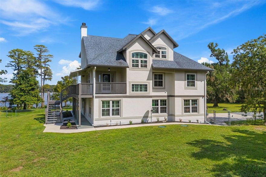 Set on nearly 11.5 acres with more than 270 feet of private shoreline along Corner Lake, this estate blends modern renovations with rare versatility. The property includes a fully remodeled main residence with an entire ground-level apartment, plus a separate guest home, dock, and boat lift on a 113-acre ski and boating lake. The main home offers more than 3,000 square feet of updated living space, a 3-car garage, and a flexible layout. Enter through the upper-level main door and you’re greeted by soaring ceilings, wide-plank white oak floors, and a fireplace that anchors the open living area. The kitchen has been completely redesigned with custom cabinetry, quartz counters and full-height backsplash, stainless steel appliances including wall-mounted ovens, and a large center island with seating. A butler’s pantry adds both function and storage. Glass sliders open to a balcony with sweeping views of the lake, while two guest bedrooms and a remodeled bath complete this level. Upstairs, the primary suite spans the entire top floor with its own balcony, double vanities, and frameless glass shower. On the ground level, a private in-law apartment features its own kitchen, living room, bedroom, and bath with direct access to a covered, screened-in porch. The guest house adds another 1,100+ square feet with a full kitchen, open living area with built-ins, bedroom with slider access outside, and its own bath with laundry. Recent updates include new exterior paint (2025) and full window replacement (2020). Multiple outbuildings convey, including sheds, a chicken coop, decking, and even a pool and tractor. The oversized garage provides plenty of workshop and storage space, with a full bath accessible from both inside and out. With county approval to split the land, this property is both a private retreat and an investment opportunity to opening opportunities to sell or build on a portion of the acreage. Expansive grounds, lakefront access, and multi-home setup, this property offers flexibility rarely found in today’s market, come and see it today!