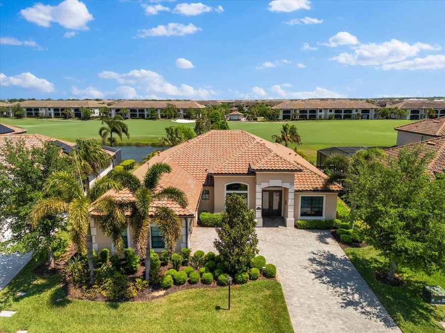 Welcome to the highly sought-after Lakewood National Golf Club in Lakewood Ranch, where a deeded golf membership is included in the HOA fees. This beautifully appointed 2,799 sq. ft. home offers 13-foot ceilings, three bedrooms, three bathrooms, a dedicated office, and a split-bedroom layout. Hurricane-impact windows are standard, and the lanai is equipped with motorized Kevlar screens for added protection. The grand foyer opens to a dramatic formal dining room with a built-in bar and wine cooler, setting the tone for sophisticated entertaining. The open concept kitchen and living room serve as the heart of the home, featuring a redesigned chef’s kitchen with upgraded cabinetry, custom hardware, quartz countertops, tile backsplash with undermount lighting, stainless steel appliances, and a generous island. A breakfast nook overlooks the pool, while the spacious living room with a tray ceiling creates an inviting setting for everyday relaxation.

The private primary suite offers serene views of the lanai and direct access to the pool. Dual walk-in closets upgraded with Closets By Design interiors complement the luxurious ensuite with dual sinks, a makeup vanity, garden tub, and a walk-in shower with dual shower heads. Two guest bedrooms are situated on the opposite side of the home, one with its own ensuite and pool access, the other connected to the hall bath with a glass barn-door shower and a walk-in closet. The office includes built-ins with quartz counters, and the laundry room adds convenience with custom cabinetry, granite countertops, and a sink.

Step outside to a private Florida oasis with a heated saltwater pool and spa overlooking hole one of the Commander Course, framed by unforgettable sunrises. An outdoor kitchen with built-in grill, refrigerator, and stone-accented hood enhances the covered lanai, surrounded by pigmy palms and lush landscaping. Located on one of the most desirable streets in the community, the home offers peace and proximity to the amenities center and front gate. Lakewood National provides two Arnold Palmer championship golf courses, tennis, pickleball, bocce, a resort-style pool, fitness center, spa, clubhouse dining, tiki bar, and 24-hour security. Lakewood Ranch is known for top-rated schools, vibrant entertainment, and easy access to Sarasota, St. Pete, upscale shopping, dining, and the Gulf Coast’s world-class beaches. This exceptional home blends luxury living with picture-perfect surroundings—your Florida lifestyle awaits.