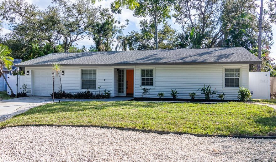 Seller concessions up to $10,000 towards closing cost with acceptable contract! Beautifully updated home on a 1/4 acre of Florida paradise. This 3 bedroom , 2 bathroom offers updated flooring, kitchen, bathrooms, fixtures, and more with a backyard that feels like Selby gardens. Inside you'll find a spacious living room with high ceilings, an eating area off the spacious kitchen with shaker cabinets, quartz countertops, marble backsplash, LG stainless steel appliance package, disposal, and built-in wine fridge and sliders to go out back. The bedrooms have low-profile fans with remote lights for the perfect comfort setting, built-in closets, and blinds. The primary suite has additional sliders to the backyard, a barn style door leading into the nicely updated master bath, while the guest bathroom offers a tub/shower combination. There are laundry connections in the 1 car garage that also house a NEW 2025 Septic system, 2025 air conditioning system, 2022 water heater, & 2021 garage door. When you're ready for some fresh air, you've chosen the right house, step outside into a very large, mature, landscaped backyard that offers the perfect blend of shade and sunlight in a tranquil setting. Lockwoods is located in North Sarasota <7mi or 10-15min of Lido Beach, University Town Center, Downtown Sarasota, I-75, Golf, Schools and MORE! Home is staged and easy to see. Call your listing agent for a viewing today!