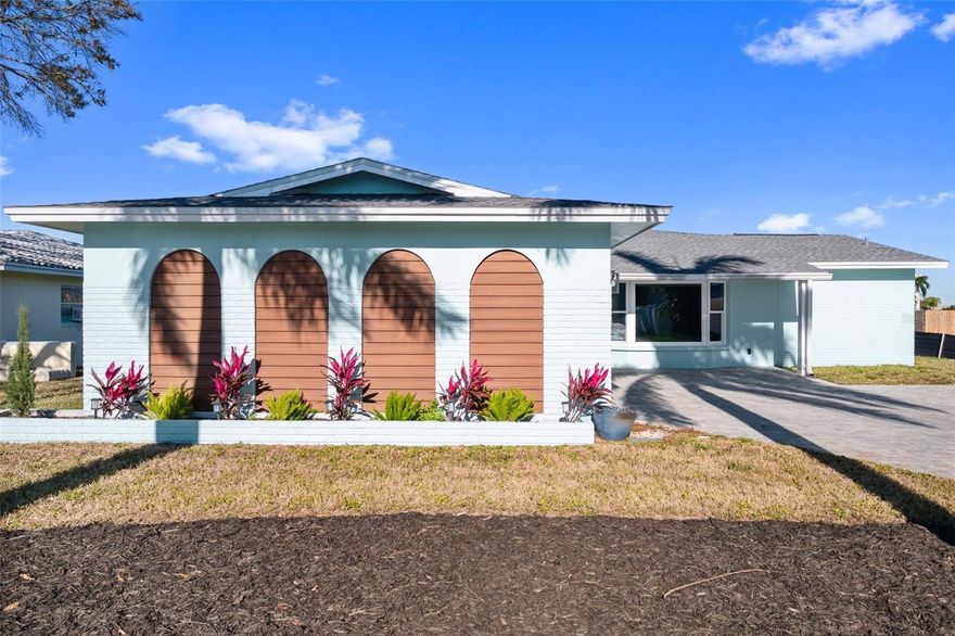 MOVE-IN READY!  ONLY $536 per square foot!!  This home has over 2400 square feet and has beautiful water views, 3-bedrooms, 2-bathrooms, a newer pool (2020), a composite dock, impact resistant windows, a fireplace, an oversized garage and inside laundry!  It features 70 feet of water frontage on a wide canal with partial views of the ICW, bay and bridge. Also, for the boaters, you have deep sailboat water and direct Gulf access with no fixed bridges. As always, the kitchen is the heart of the home, and it features new higher end appliances.  The best sunsets on the coast are only a short drive or an 8-to-10-minute walk away. Flood insurance is transferrable and is only $2702.00/year!   Beautifully staged by the Aro Chic Team.