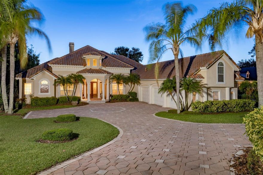 A captivating Mediterranean-style home offers a Winter Park Chain of Lakes lifestyle on Lake Minnehaha with sweeping sunset views over the infinity edge pool. Serenity and privacy are at the forefront of this open living plan with volume detailed ceilings and large-scale windows and doors that frame the view of the water. A four-way split bedroom plan, mostly all one-level living which is a rare find with nearly 4,000 square feet. One bedroom suite is upstairs with a dedicated bath and bonus space. Formal living with grand fireplace, dining spaces and dedicated office as you enter through an open foyer with kitchen at the center of home overlooking gathering space to lake. The kitchen is spacious with lots of workspace, and features warm-wood 42-inch cabinetry, center island and bar seating as well as eat-in kitchen space, granite countertops, stainless appliances and spacious pantry. The owner’s retreat also overlooks the lake, large enough for a sitting space or secondary office area and fabulous bath with dual vanities, walk-in shower, and a soaking tub as well as a walk-in closet. Family space opens to a covered porch, with summer kitchen and pavered deck with plenty of space to soak up the sun. Adventure awaits as the boathouse makes life on the lake easy, dock your pontoon, ski boat or kayak and navigate the canals through six different lakes on the chain, all the way to Park Avenue and Rollins. Other features include oversized lot, iron-detailed wind closet, en-suite bedrooms with bath, inside laundry, skylights, three-car garage, pavered circle drive with parking pad, timeless barrel tile roof and mature landscaping. Dommerich is a highly desirable Maitland neighborhood with proximity to Maitland Community Park, near Dommerich Elementary School, Maitland Middle School and zoned for Winter Park High School. Maitland is one of the greatest Central Florida communities with easy access to roadways, fantastic restaurants, Lake Lily Park, Sunday Farmer’s Market and lots of programming from the city. No better place to call home. Call us today for a private showing.