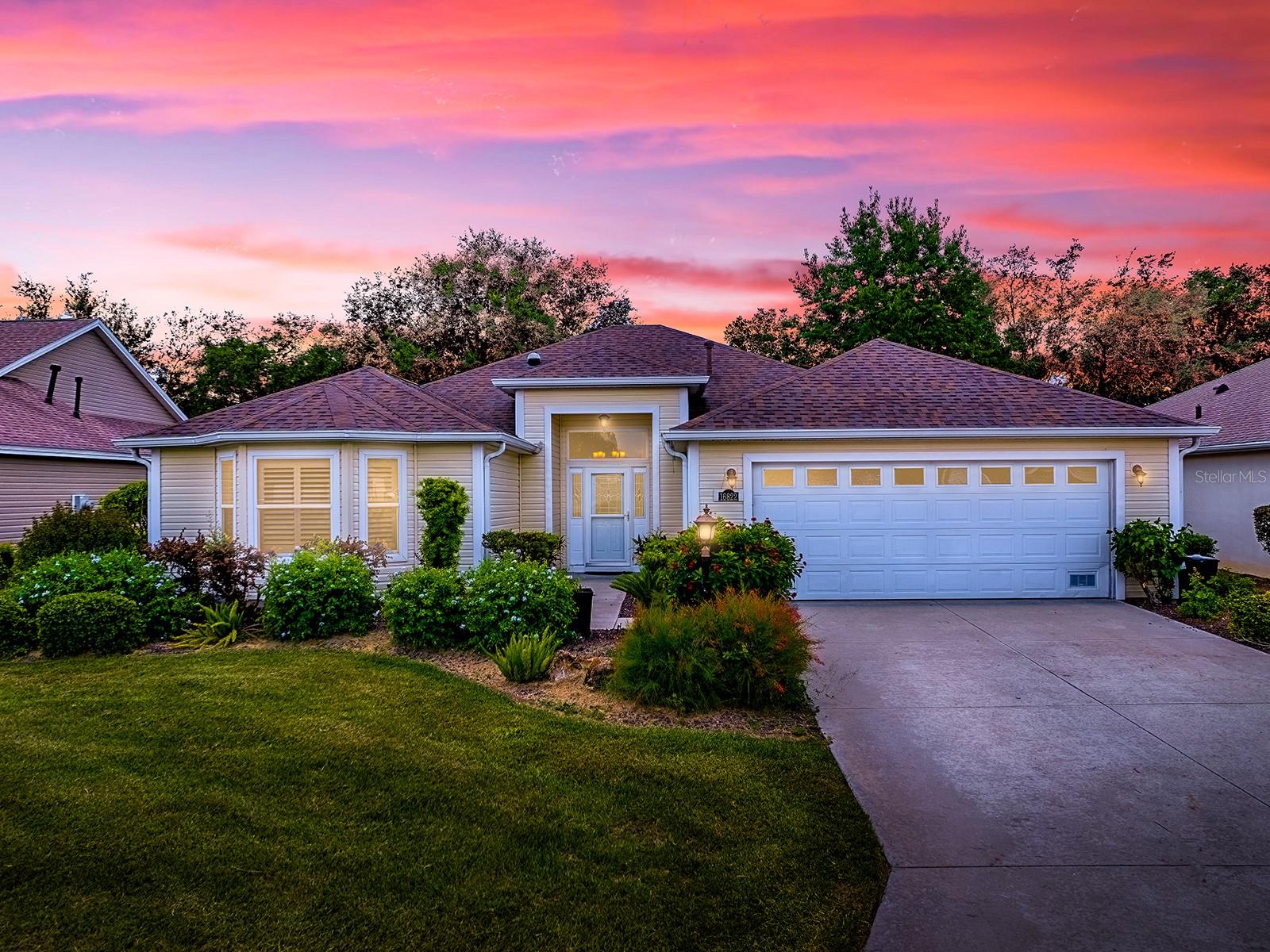 GOLF FRONT LIVING WITH NO BOND! This beautiful 3 Bedroom, 2 Bath Juniper/Lantana model is ideally situated on the Nancy Lopez Championship Golf Course in the sought-after Village of Calumet Grove. With nearly 2,000 square feet of well-designed living space, this home is filled with upgrades and charm.
Step inside to find neutral tile LAID ON THE DIAGONAL, PLANTATION SHUTTERS throughout, and custom crown molding, chair rail, and wainscoting that add elegance to every room. The kitchen is a chef’s delight with GRANITE COUNTERTOPS, subway tile backsplash, wood cabinetry, and a welcoming OPEN LAYOUT.
The spacious master suite features a vaulted ceiling, double vanity, and a luxurious SOLID SURFACE JETTA STONE shower with frameless glass door. The split floor plan provides privacy for guests with two generous bedrooms and a guest bath showcasing granite counters and a tiled tub/shower combo.
Enjoy peaceful mornings and relaxing evenings on the expansive lanai with river rock flooring and SPECTULAR GOLF COURSE VIEWS. The OVERSIZED garage includes pull-down stairs and extra storage, while the whole-house water softener system ensures comfort and convenience.
Located just minutes from the LOPEZ LEGACY COUNTRY CLUB, this home offers luxury, location, and lifestyle—all with NO BOND ROOF 2021 and PRICED TO SELL!
