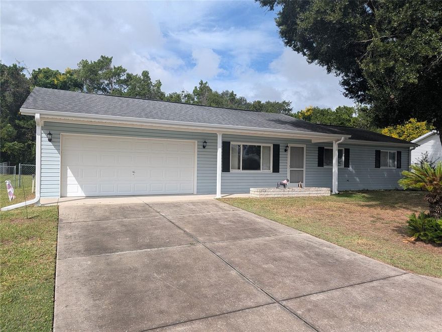 Looking for that "perfect size"  modest and affordable Florida home? Then you won't want to miss this charmer  located in Spruce Creek  South, one of Central Florida's most desirable and affordable retirement communities. This well maintained 2 br, 2ba, 2 car garage home is situated on a modest lot with a fully fenced, private backyard, this home offers both comfort and privacy. Enjoy relaxing on the bright enclosed lanai with a good book or favorite beverage. Recent upgrades include new carpeting throughout, new coach lights, shutters,  fresh interior paint, a new rear entry door with security lock, a water heater replaced in 2023, a roof installed in 2017, and an A/C unit in 2014. Experience the convenience of of worry free public services such as water and sewer! Spruce Creek has lots of clubs and activities to keep you busy, and lets not forget how close it is to the finest entertainment including the Villages and Ocala. Close to shopping, dining, and all types of medical offices. Don't miss the opportunity to make this your new home!