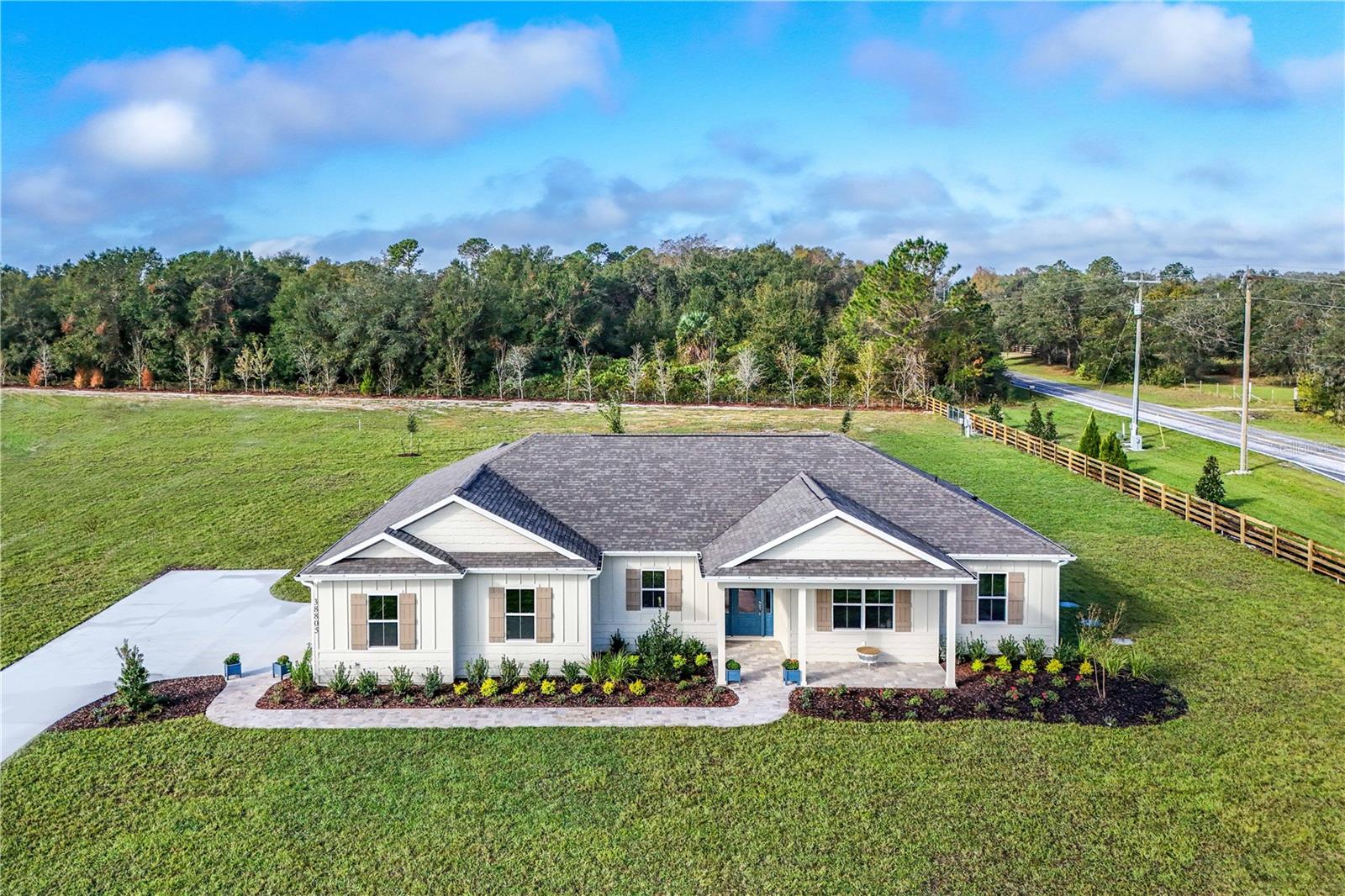 Welcome to the new Shoreline Ranch Community. This beautiful 4-bedroom 2-bathroom home with stunning landscaping on a 1-acre lot is located in Lake County, Florida. Featuring floating cabinets with LED lights in both bathrooms, heated pool with screen enclosure, a lot of storage space, quartz countertops with undermount sinks, porcelain wood plank tile in main areas, solar panel ready, EV charger installed in garage, stunning vapor fireplace with tv, community boat ramp and dock, professionally landscaped lawn, kitchen backsplash with undermount lighting, brick pavers for lead walk, front and rear porch, and oversized pantry with cabinets. Contact us today for a showing. This home is Builder model in Shoreline Ranch community available now for purchase with an October 2025 move in.