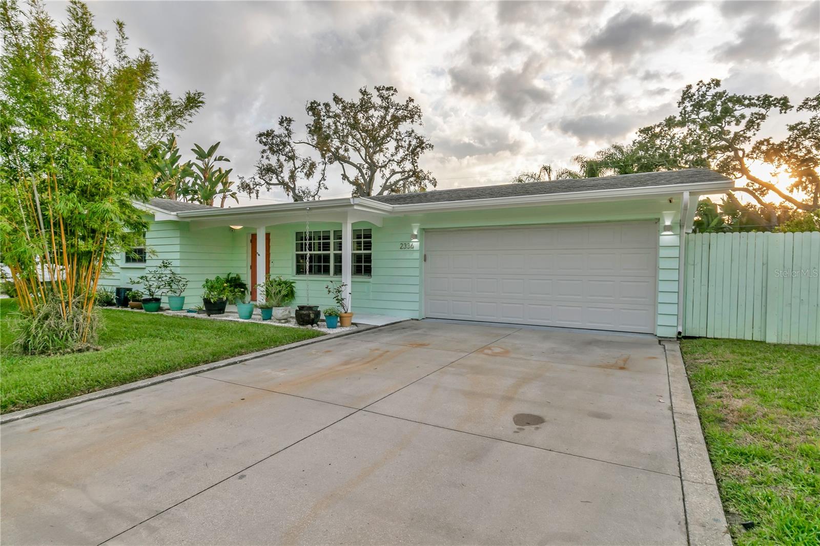 Welcome to your next chapter in Dunedin’s Fairway Estates— Appraised within the last 30 days at $660,000, this updated, move-in-ready home embodies comfort, convenience, and Florida charm. Nestled in a non-flood zone (Flood Zone X), it offers peace of mind alongside its prime location—just minutes from the beach, shops, restaurants, and the Dunedin Golf Club. Hop on your golf cart and explore the Art Center, quaint downtown, or cruise the neighborhood—everything’s close and accessible. Inside, you’ll find a fresh, thoughtfully renovated space featuring granite countertops, a sleek eat-in kitchen with ample storage, and stylish bathrooms. The split layout is ideal—low-maintenance yet spacious enough for hosting friends or relaxing with family. Picture mornings at the kitchen counter, coffee in hand, with soft-close drawers and stainless appliances at your fingertips. Out front, the porch and lush yard (hello, clumping bamboo!) create a peaceful welcome. Out back, the fully fenced yard is perfect for pets or privacy, and the saltwater pool and hot tub make entertaining effortless. You can step out to the pool from the kitchen, lanai, or primary bedroom—talk about flow. The air-conditioned lanai, complete with a wet bar and built-in fridge, is ready for your next get-together or a quiet night in. With updates like a newer HVAC condenser, new water heater, updated windows, and garage door, the practical perks are covered too. This isn’t just a house—it’s a laid-back, well-loved home in one of Dunedin’s most desirable neighborhoods.
