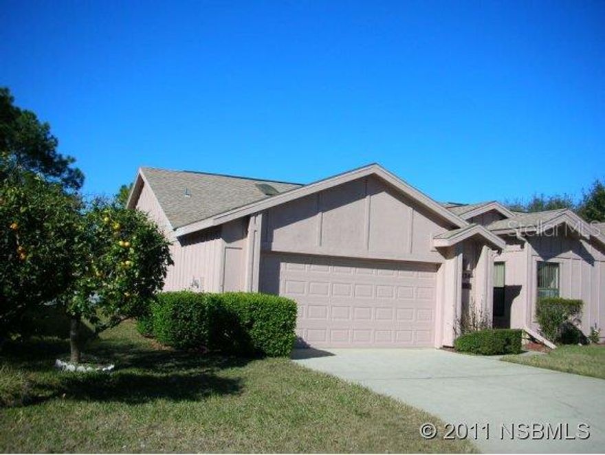 Available for immediate occupancy! Make this your vacation retreat or year round abode with this Woodside Villa located in the prestigious Spruce Creek Fly-in, a gated country club community. This spacious one-level home is the largest Woodside Villa & has been recently renovated with granite countertops & new stainless appliances in the Kitchen plus granite countertops in both bathrooms. The Living Room features a wood-burning fireplace. Ceramic tile floors throughout the home except carpeted bedrooms. Spacious Master Suite has a large walk-in closet, His & Her granite vanities with separate dressing area. Bedroom #2 with attached bath is located in the front of this home to give additional privacy. Bedroom 3 is perfect as a Den/Office. The Florida Room is a bonus & adds additional living space.  This home is well-priced at a low $71 per sq. ft. The monthly HOA for Woodside is $400 & covers insurance on the building, termite bond, exterior maintenance, painting, roof, lawn care & community pool. The 2014 POA fee is $1,400 & includes 24/7 security, maintenance of private streets, airport, taxiways, parks & common areas. Whether you are an aviator, golfer or just love life in a secure community, here's the care-free lifestyle you deserve in walking distance to the Spruce Creek Country Club & golf course & a 15 minute drive to World's Most Famous Beach, speedway, shopping, theatres, medical facilities, schools, Embry Riddle Aeronautical University & 1 hour to Orlando. ;LocationDescription: Condo ;Water: City