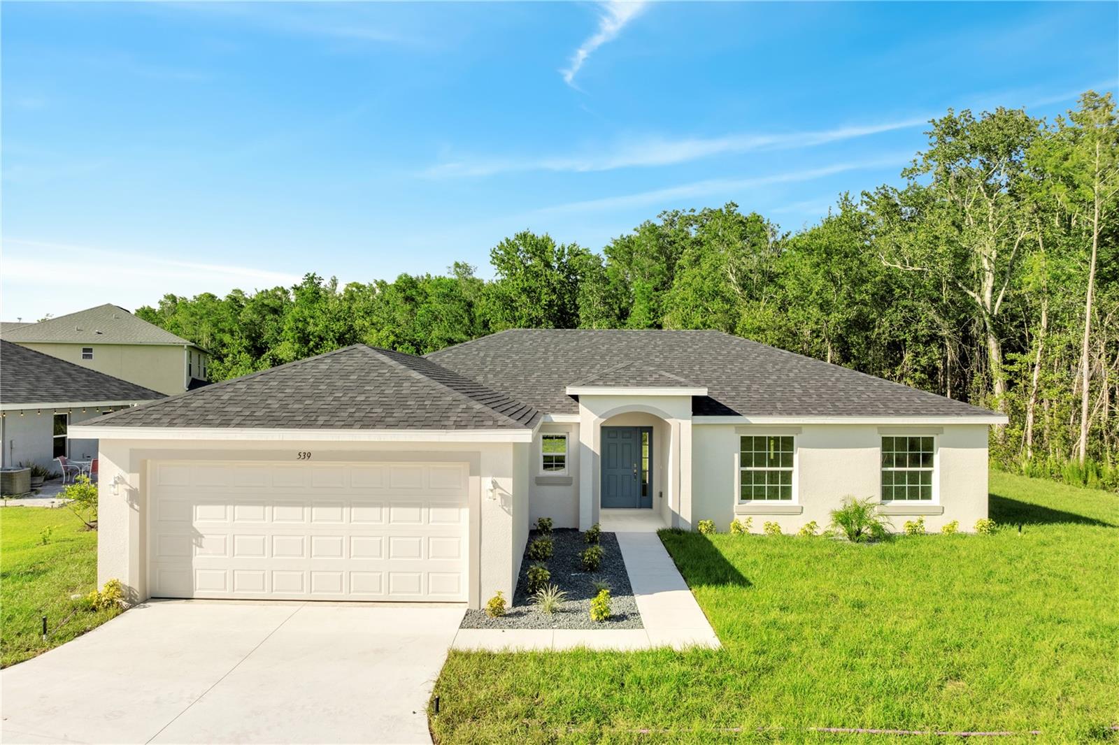 FULLY COMPLETED -- ALMOST HALF ACRE LOT -- MOVE IN TODAY! ASK ABOUT BUILDER INCENTIVES FOR CLOSING COSTS OR RATE BUY-DOWN! Welcome to the "Cypress" model by Honesty Homes! This open-concept, concrete block home features high-end finishes and numerous upgrades throughout. You'll find 42" cabinets in the kitchen and bathrooms, sleek granite countertops perfect for culinary creativity, and soaring vaulted ceilings that enhance the sense of space. The master bedroom offers indulgence with its vaulted ceiling and two spacious walk-in closets for ample storage. Both bathrooms are thoughtfully designed with generously sized tubs and modern tiled showers, ideal for relaxation. Schedule your showing today, and don't forget to inquire about the builder's preferred lender for special incentives!