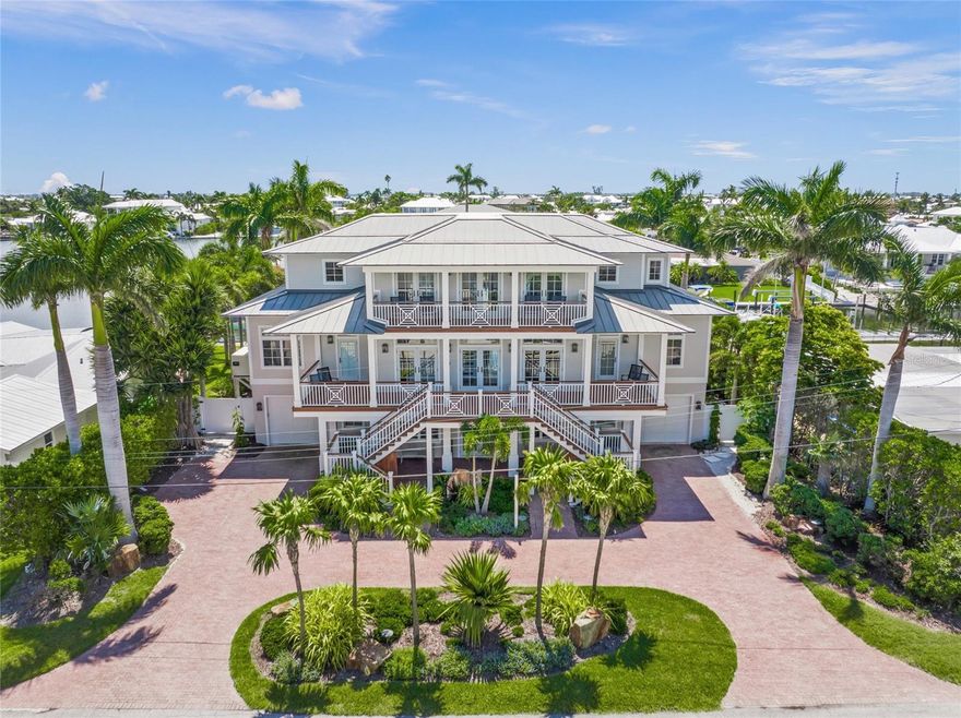 Coastal Luxury at its finest. This elegant three-story waterfront home offers 5 bedrooms, 6 bathrooms, and over 4,000 sq ft of beautifully crafted living space. Located on a peaceful canal just moments from the beach, it features soaring ceilings, custom finishes, and an elevator to all levels. Multiple balconies showcase stunning views, while the outdoor oasis includes a saltwater pool, spa, and full summer kitchen. With direct access to Tampa Bay and the Gulf, this is truly a boater’s paradise.