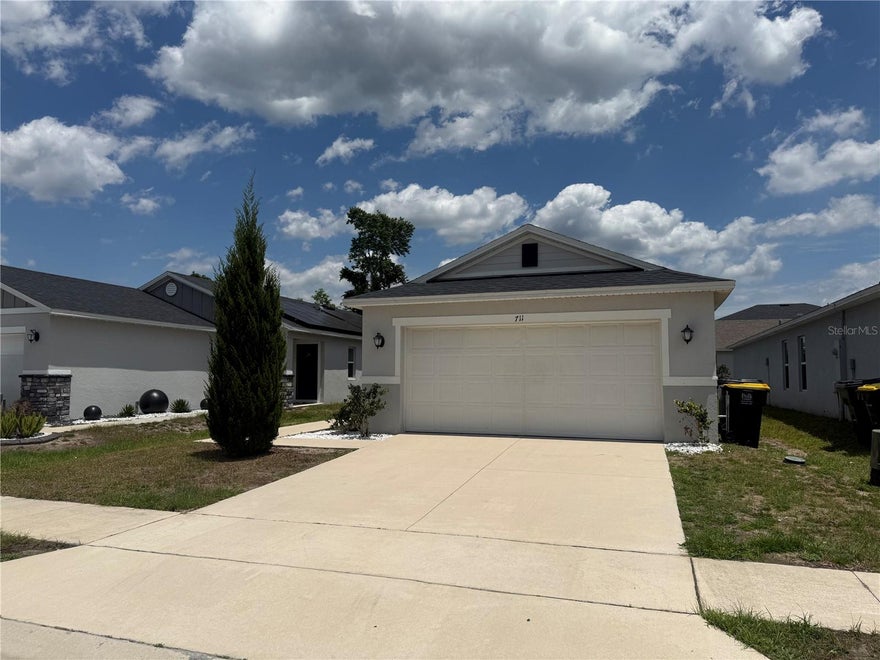 This stunning one-story split floor plan home is sure to impress from the moment you step inside, freshly painted with modern features is ready to welcome a new family. The entry hall leads to a spacious great room featuring 9- ft. ceilings and access to a covered patio ideal for outdoor entertaining. The modern kitchen showcases modern kitchen cabinets, a flat island with granite countertops and stainless steel appliances. Three spacious bedrooms with large closets and the main bedroom which includes a spacious walk-in closet and connects to the large master bath which boasts an extended walk-in shower with tile surround, an extended dual sink vanity and a linen closet. Centrally located between Hwy 27 and US 17-92, off Ridgewood Lakes Blvd., short drive to shops and attractions.