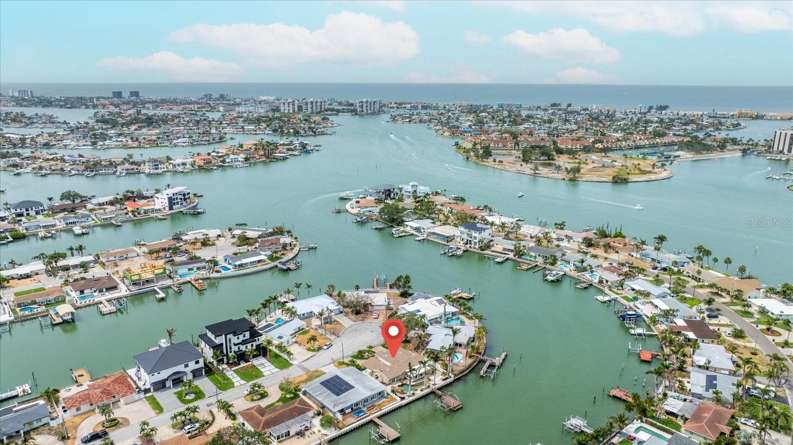 This is a must-see home—fully remodeled with impeccable taste and attention to detail throughout! Nestled in the highly desirable waterfront community of Causeway Isles, this stunning residence offers the perfect blend of luxury, style, and coastal living. Step inside to discover a bright, open floor plan, 4 bedrooms, 2 bathrooms, with all-new walls, outlets, luxury vinyl and tile flooring, solid wood cabinets, quartz countertops and backsplash. The chef’s kitchen shines with brand-new appliances, a double oven, dishwasher, lots of cabinets, an island with storage, floating shelves, and a beautiful water view. There is a spacious butler's pantry with sink off the kitchen which can double as a mud room, with a plethora of cabinets for storage, and large separate laundry room for added function. You will love the stylish wine bar complete with wine refrigerator—perfect for entertaining. Every detail has been thoughtfully upgraded: Gorgeous new light fixtures throughout, Modern vanities and sinks in fully renovated bathrooms, a sunroom featuring all-new hurricane impact windows and slider, perfect for game night or relaxing with a good book. Primary Bedroom has double vanity in the en-suite bathroom, walk-in closet with custom built-ins, and a slider direct to the pool and backyard. Outside, enjoy a private pool and spa, (salt system), boater’s dream amenities including a dock, davits, 10,000 lb boat lift, and no fixed bridges for quick Gulf access. New roof in 2021, paver driveway 2023. Installed after storms: new pool pump and pool heater, new HVAC system with warranty, new electric water heater. Property treated for pests inside and out monthly, lawn treated with fertilizer when appropriate, cut and trimmed weekly. Located just 2 miles from Treasure Island beaches and minutes from vibrant downtown St. Petersburg, you’ll love the proximity to dining, music, art, and the scenic Pinellas Trail. This turnkey coastal retreat truly has it all—schedule your private tour today!