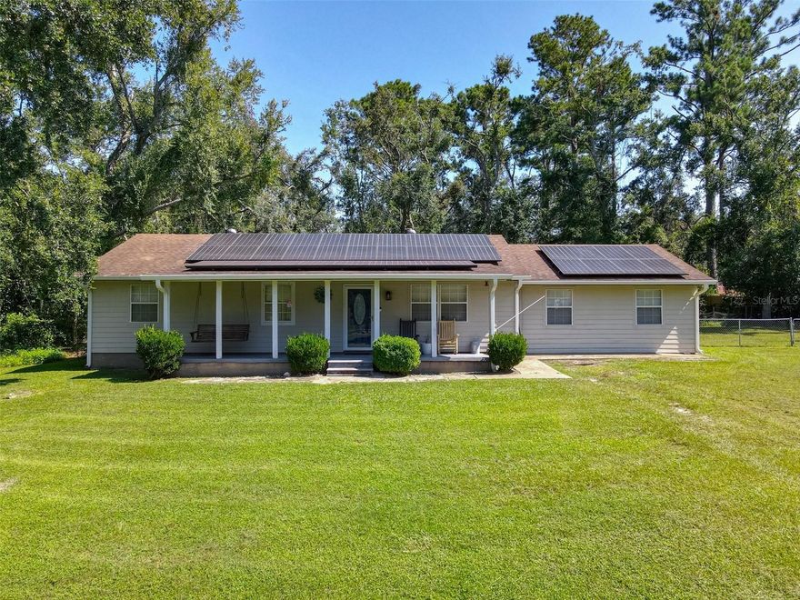 Welcome to this charming and versatile 3-bedroom, 2-bathroom home nestled on over an acre of land, just 4 miles from the heart of Live Oak. With 1,528 square feet of well-maintained living space, this home offers comfort, style, and flexibility for a variety of lifestyles.

Step inside to find tile flooring throughout, giving each room a clean and timeless feel. The spacious family room/game room offers endless possibilities—it can easily function as a second living space, home office, or even a fourth bedroom for guests or a growing household.

The kitchen features stainless steel appliances and a smart layout, perfect for everyday cooking or entertaining. Enjoy your morning coffee on the inviting front porch, or unwind in the fenced backyard, offering plenty of space for pets, gardening, or weekend barbecues.

Even better? This home comes equipped with solar panels, offering energy savings and eco-friendly living.

If you're looking for a peaceful retreat close to town with room to breathe and space to grow, this is it! Come see why this property is the perfect place to call home.
