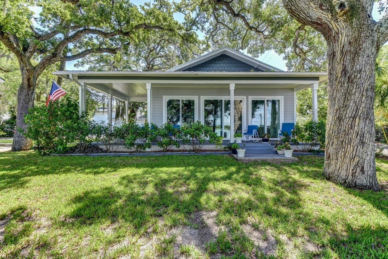 120 ft of direct intracoastal waterfront property, sub dividable mixed use zoned "off Flagler" property with riparian rights. 0.62 acres fenced with mature trees, a dock and 3 structures as follows: Newest home is a yr 2015 frame direct intracoastal 3 bed 2 bath with a wrap around front covered porch and back covered porch. It is situated within a hammock of towering oak trees and it features a waterfront living room with coffered ceilings, an open floor plan and bamboo floors. The second structure a block/frame, is the old "Mr Ryan's" fish camp home year 1953 direct waterfront where the fisherman docked his "Margaret A" fishing boat (named after his wife). It is a bit older structure that could use updating. It is a 2 story structure with an old built in walk in refrigerator cooler on the first floor. The third structure is a combination 48 ft RV garage/ garage/ workshop with half bath, it has a 12x14 roll up RV garage door, blown in icyene insulation , 200 amp service. This mixed use property if divided has lot requirements width of 50 feet, a 20 ft front yard, 10 ft rear yard set back and 42 ft max height(refer to mixed use zoning) allowing apartments, B&B, multifamily, restaurants, hotels and more. Columbus Ave is a peaceful quiet area half block to Flagler Ave area shopping & restaurants and a 4 block walk to the beach. After a long day's work it is a perfect location to enjoy an afternoon cool beverage while watching passing boats and dolphins. ;Water: City