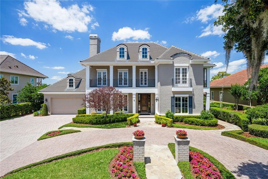 The BEST of the BEST...Impeccably Renovated Windermere Charmer on the Butler Chain! Welcome Home to the BEST of Florida living.... with water views, iconic downtown Windermere setting on a paved road, and direct frontage on Wauseon Bay. Nestled on the historic Bumby Peninsula, this 5,639 square foot Stonebridge custom 5 bedroom/4 full/2 1 /2 bath home blends the finest of designer details with relaxed Southern charm. Views of the water abound from nearly every room... even the staircase was designed to take advantage of the water views. Relax on your multitude of screened double stacked porches, balconies and expertly pavered patios, all perfect for al fresco dining, enjoying the sunset and endless water views year-round. The formal areas of the home are expansive, offering a perfect setting for entertaining and taking advantage of sparkling water views. A first-floor office, tucked privately off the main entrance, features custom millwork and shelving, flanking a gas fireplace. The crown jewel of the home. is the recently renovated kitchen and dining space, featuring coveted luxuries such as custom 3-sided stainless steel range hood, custom dove grey cabinetry, Sub Zero refrigeration, Wolf Gas cooktop, 2 ovens and warming drawer, a walk-in pantry, pure quartzite countertops and island. The kitchen also features direct access to the screened porch, with full summer kitchen, retractable screens, and large dining area, overlooking the water. The first-floor primary bedroom is generous in size featuring two walk in closets, en suite bath with separate tub and a large shower, with two shower heads. Upstairs, four bedrooms each with direct bathroom access, custom built-ins and generous storage offer room for all. A unique upstairs bonus room is adorned with custom bar, three TVs (which convey) and a private screened balcony, perfect for entertaining and game day! Another bonus room, with generous storage, is located on the other side of the upstairs and could be a 6th bedroom if needed. Meticulously maintained with peace of mind features including: full house generator, new roof (2019), two new hot water heaters, Pella windows, Trane AC, central vac and more! Outside, unlimited space for all types of entertaining abound. Multiple pavered patios, a built-in brick gas pit with seating, green space, manicured grounds, private bathroom, outdoor shower and the piece-de-resistance, a boathouse with electric, water, boat cover and space for dining or simply enjoying the peaceful sunsets. Enjoy boating, waterskiing, fishing and more on one of 11 interconnected lakes that make up the world-renowned Butler Chain right from your backyard. Take part in the eclectic mix of shops, dining, brewery, farmers market and parks that are just a short walk or golf-cart ride away in downtown Windermere. All of this combines to ensure a Florida lifestyle like none other. All the work has been done for you....come begin living your dream today!