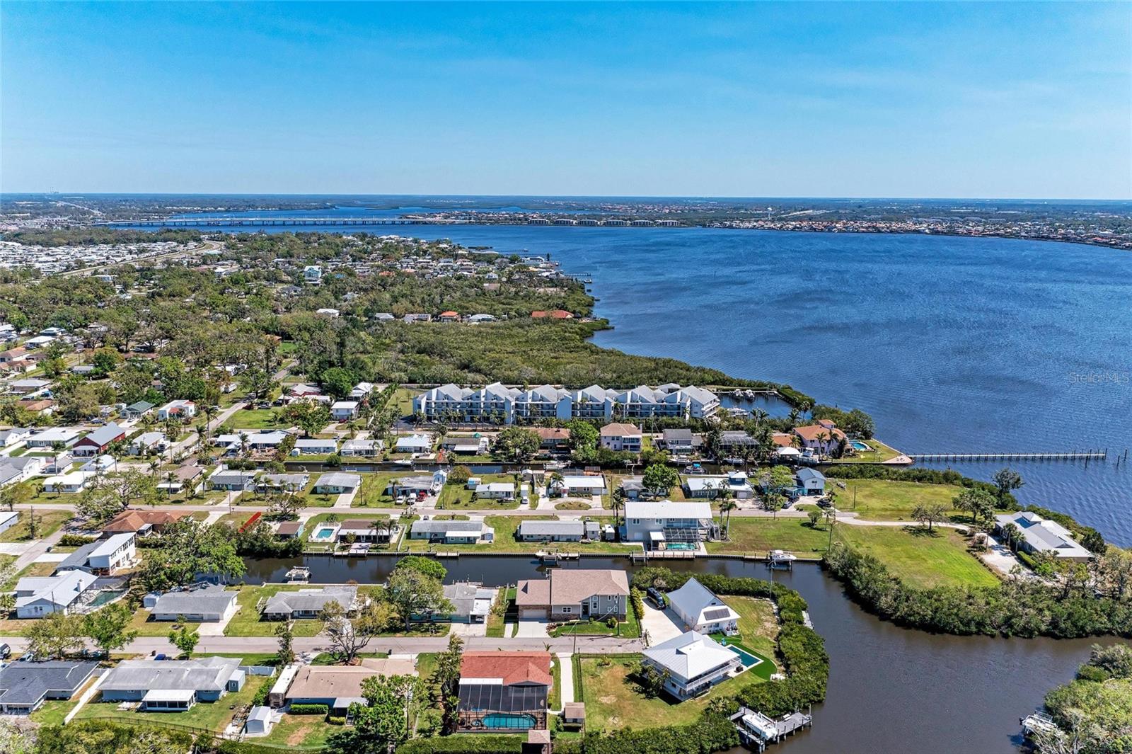 ATTENTION BOATERS!!!! A rare find in Manatee & Sarasota counties—an updated condo under $400k includes a DEEDED boat slip with your condo fees! Welcome to River Place—a waterfront condo community on the Manatee River west of I75 in Ellenton. This beautifully remodeled 2-bed/2-bath condo offers a rare opportunity for waterfront living with a host of enticing benefits. The prime location of River Place takes you 20 minutes (by boat) to the pristine shores of the Gulf Coast restaurants and fantastic beaches. This ideal mix of convenience and water access living makes it a gem for those seeking the best of both worlds. Another standout benefit is the deeded boat slip, equipped with a 10,000 lb lift, water, and electric, providing direct river access to the Gulf coast. The marina has a boat house and convenient fish cleaning station provided by the condo association for your “catch-of-the-day”. Recent renovations include an open floor plan, large kitchen with wood cabinets & large breakfast bar (counter-height seating), GE stainless steel appliances, granite counter surfaces, neutral luxury vinyl plank flooring throughout the main living areas, single panel doors, lighting, ceiling fans, and both bathrooms have been completely remodeled. A newer air conditioner installed in mid-2020 ensures energy efficiency and comfort. The condo's interior has been thoughtfully designed in a contemporary coastal look, making it move-in ready. This contemporary decor adds to the overall appeal, providing a seamless blend of style and functionality. Step out the triple door pocket sliders onto the huge, screened balcony and enjoy your morning coffee overlooking the community and the water. In addition to the exceptional living quarters, worry-free living is facilitated by the Condo Association which includes essential services such as water, sewer, trash, cable TV, maintenance, and flood insurance. Additional amenities include community grill area, a car wash station, a large 10x6’ storage room in front of your two designated parking spots (under building). Furnishings are negotiable—in case you only want to bring your suitcase! No special assessments and several community projects are underway for tennis court repairs, power washing and dock damage (synthetic wood replacement) due to storms—no major damage to the buildings. Also, the owners’ boat was secured on the boat lift during both storms with no damage!! Storing a boat at a local marina will cost more than $600/month and be limited to their hours of operation. Act now to secure your chance to make this coastal haven your new home. Boat available for sale under separate contract. Easy commute to anywhere around town and located close to dining, shopping, medical facilities, I75, and more. THE POSSIBILITIES ARE ENDLESS so schedule your showing today!