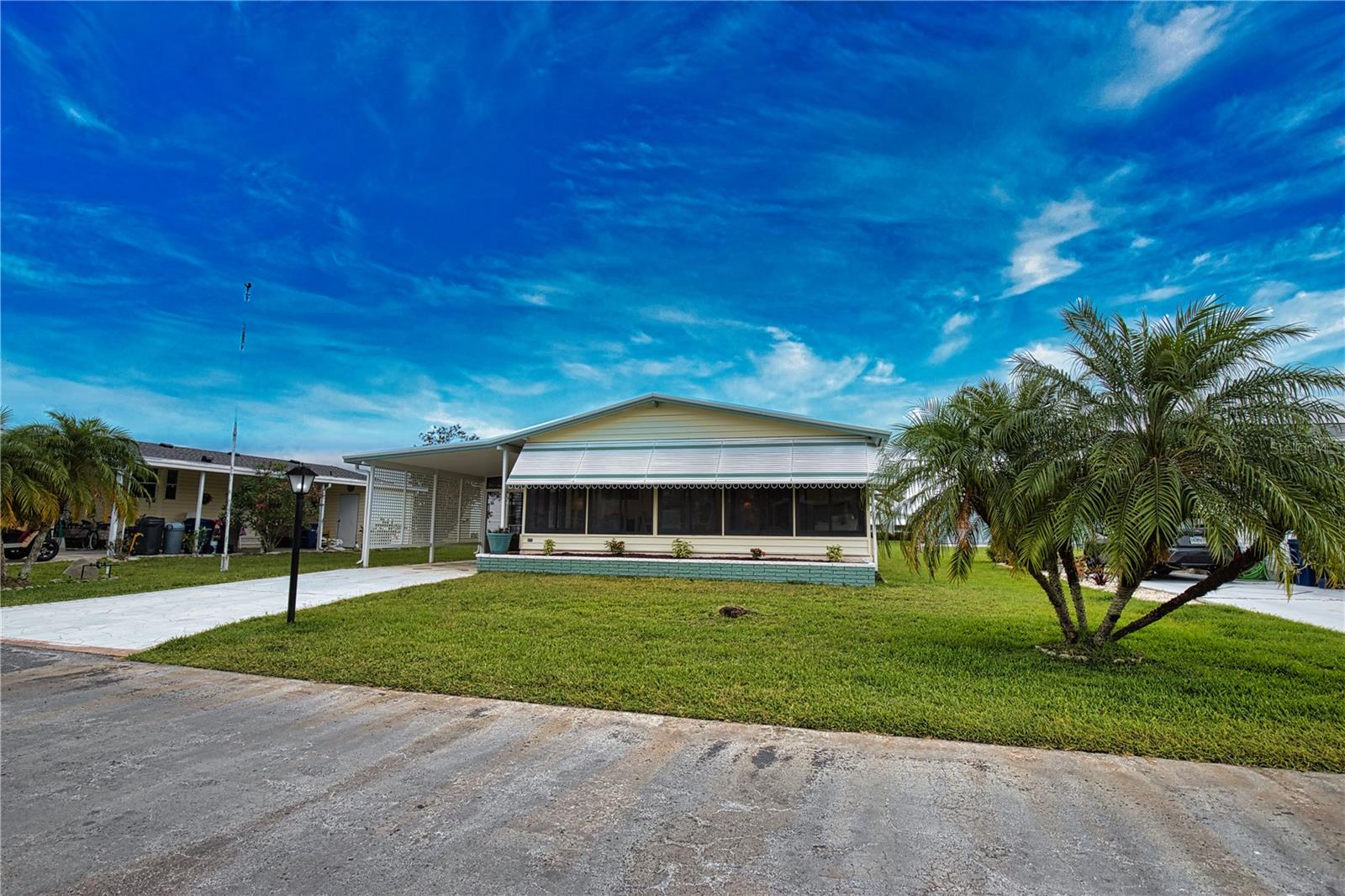 Step inside this captivating 2-bedroom, 2-bath gem, where an open floor plan greets you. The remodeled kitchen shines with a pantry, a skylight that bathes the space in natural light, modern appliances, and a convenient pass-through window that connects to the cheerful Florida room. The elegant dining room features a built-in hutch, while the living room, with its sliding door, opens to a sprawling acrylic-enclosed Florida room measuring 10' x 24', adorned with front awnings and a door leading to the carport. Retreat to the primary bedroom, which includes both a walk-in closet and an additional spacious double closet. Its remodeled dressing area features a stylish double-sink corner vanity and a dedicated dressing table, complemented by a solar tube skylight for an inviting ambiance. The primary bath boasts an indulgent walk-in shower and elegant luxury vinyl flooring. The guest bedroom, complete with a generous walk-in closet, offers a comfortable retreat. The beautifully updated guest bath showcases a new vanity top, a new commode, luxurious vinyl flooring, and a delightful solar tube skylight. A handy linen/utility closet is conveniently located in the hallway. With luxury vinyl flooring and new subfloors throughout the kitchen, dining room, hallway, and partially in the living room, this home exudes both style and comfort. The newly replaced windows enhance the brightness, while the vaulted ceilings in the kitchen, dining room, living room, and primary bedroom create a sense of openness and elegance. Recent upgrades ensure peace of mind, including a new water heater (October 2022), a new electrical panel box (December 2018), and a new AC unit (July 2022). The property's well-planned enhancements also involve replaced tie downs, new vapor barrier, and floor insulation just completed in 2025, along with a humidistat and ceiling fans for added comfort. Outside, a beautifully painted concrete driveway leads you to a spacious screened lanai and a utility room equipped with a washer, dryer, and ample storage. With a host of thoughtful upgrades and charming features, this lovely home is your ticket to tranquility on a picturesque street in La Casa. Discover the ultimate lifestyle on Florida's stunning Gulf Coast, perfectly nestled between the vibrant communities of Sarasota and Fort Myers, with convenient boat access to the sparkling waters of the Gulf. Welcome to La Casa, a serene 55+ community that boasts 974 charming homes, enveloped by lush native trees and beautiful common areas that showcase eight delightful lakes. Embrace the Good Life! This vibrant community offers abundant recreational opportunities, including two inviting clubhouses and two heated pools, ensuring there’s never a dull moment for residents seeking both relaxation and adventure. Embrace your dream lifestyle today!