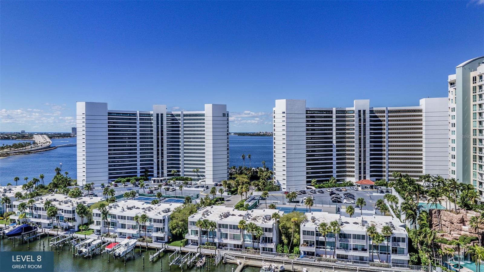 One or more photo(s) has been virtually staged. Pre-Construction. To be built. This 20-story Ritz-Carlton Residences tower enjoys a prime waterfront location in the heart of Sarasota’s walkable downtown cultural district. Residence #705 is at north end of the tower and optimizes beautiful vistas of Quay Harbor, The Bay Park, Sarasota Bay and the Gulf of Mexico. Its impressive Residence E design features soaring walls of glass that create an expansive and luxurious great room experience. This spacious area is accentuated by a wraparound terrace with a summer kitchen. The primary bedroom offers a breathtaking bay view through dramatic, oversized windows, complemented by two generous walk-in closets. The spa-style bath boasts a deep soaking bathtub, a double shower and double vanity. Additionally, two guest bedrooms each come with private en-suite baths and access to a separate east-facing wraparound terrace. In The Ritz-Carlton global tradition of peerless service, this private residence will enjoy a dedicated on-site team that takes pride in anticipating every need and fulfilling every wish. A 24-hour dedicated staff and concierge, food and beverage services available from a private, on-site service kitchen, dedicated 24-hour valet, housekeeping services and an impressive array of private amenities overlooking the sparkling yacht harbor. In addition to exceptional private amenities and services available exclusively to tower residents, membership in The Harbor Club provides access to nearly 20,000 square feet of amenities dedicated to socializing, health and wellness.
