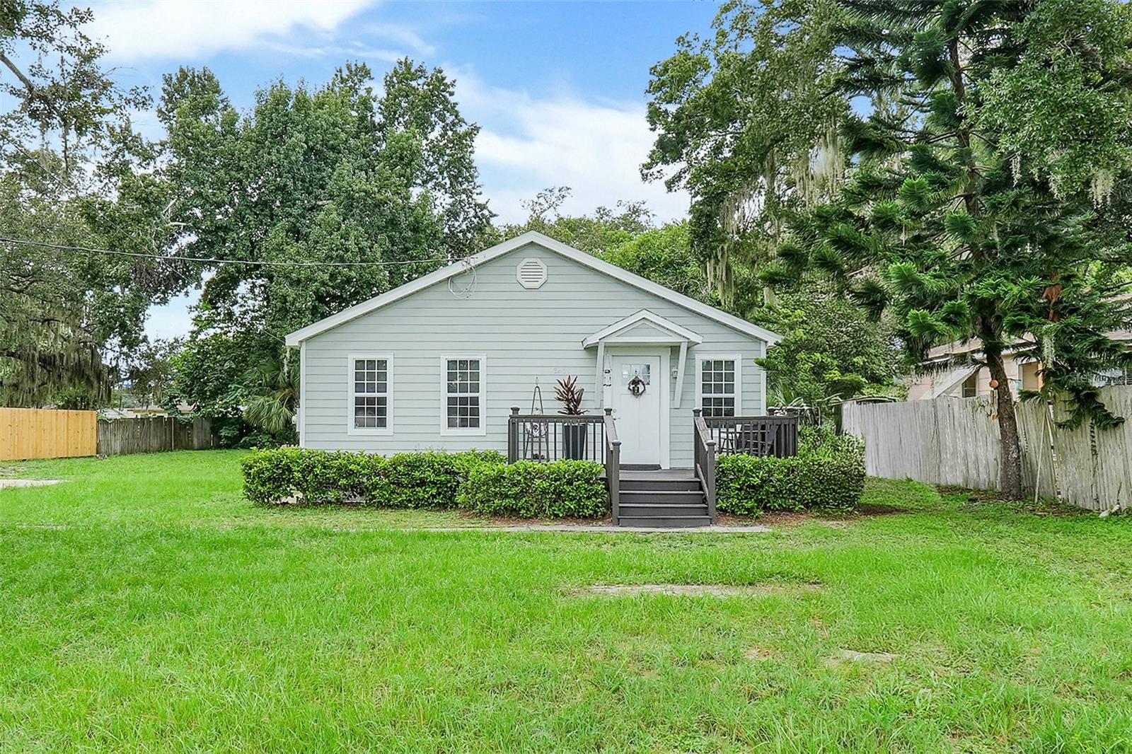 Welcome to your new home or next investment opportunity! Conveniently located just steps from the Orlando Sanford Airport, this charming 2-bedroom, 1-bath home sits on a generous 0.41-acre lot, offering plenty of space and possibilities.
As you arrive, you’re welcomed by a raised front deck that sets the tone for this inviting property. Inside, the open-concept layout features a modern kitchen with granite countertops, stainless steel appliances, abundant cabinet space, and a spacious island perfect for barstool seating. The adjoining living area—currently used as a dining space—offers flexibility to create a cozy setting that suits your lifestyle.
The primary and guest bedrooms are tucked just off the main living area, with a full bathroom down the hall showcasing a shower/tub combo and granite vanity. The guest bedroom includes direct access to the back deck, where you’ll also find the laundry area.
Outdoors, the oversized backyard is a blank canvas with endless potential. There’s also a dedicated space beside the home, previously used for RV/trailer parking or even a container home—ideal for those needing extra storage or creative use of space. In fact, the sellers currently have a container home that they are willing to sell separately and place back on the property if the buyer is interested. With its prime location and versatile layout, this property is ready for the right buyer to make it their own. Don’t miss your chance to unlock all the potential this home has to offer!