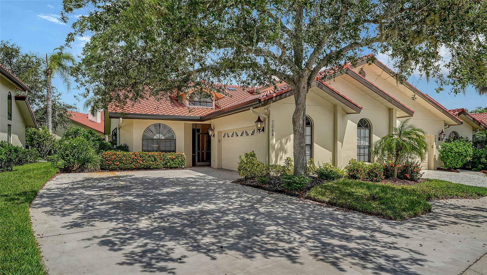 From the moment you enter this 2 bedroom, 2 bath villa, it is clear that this is not just another home, but a masterfully reimagined sanctuary—one where every detail speaks to the discerning eye and every amenity radiates comfort and style. Over the last three years, this home has undergone an extraordinary, designer-inspired remodel, transforming it into a showcase of contemporary elegance and thoughtful functionality. The transformation of this home began in 2022, with a bold vision to create a living space that seamlessly blends modern sophistication with everyday practicality. The journey commenced with the renewal of all wall textures and a fresh coat of paint, setting the stage for a new era of style. Gone are the dated finishes, replaced by a palette that is both inviting and timeless, reflecting the natural light that pours in from every angle. Outfitted with top-of-the-line KitchenAid appliances, the kitchen has been elevated to a place where every level home chef can create casual meals and culinary masterpieces. The new sleek white cabinetry offers ample storage. Quartz countertops gleam beneath exquisite lighting. The dining area has a built-in buffet. The master suite is spacious with enough room for a private sitting area. Step into the master bathroom and enter a realm of relaxation and indulgence. A huge two-person shower stands as the centerpiece, inviting you to unwind after a long day. The rain shower heads and body sprays envelop you in a spa-like experience. Adjacent, a free-standing soaking tub beckons, promising quiet moments of retreat and rejuvenation. Set against a backdrop of refined tilework and illuminated by soft lighting, this bathroom rivals the finest resorts. The second bedroom is large, and the guest bath also features a fabulous, albeit smaller, shower. The living room opens to the formal dining area and features a fireplace and wet bar. The cozy den has doors to an enclosed patio with ceiling fan, the perfect place to enjoy lunch in the afternoon or dinner on a beautiful Floria evening. Throughout the home, lighting has been thoughtfully curated—not just as a utility, but as an art form. Fixtures cast a welcoming glow, highlighting architectural features and lending ambiance to every room. In the living spaces, custom plantation shutters offer classic elegance, while electric blinds provide convenience and control at your fingertips. The interplay of natural and artificial light creates an environment that is at once dynamic and soothing. Completing this transformation is A BRAND NEW ROOF. Add to all this a two car garage, a large laundry room with cabinets and utility sink, and there is nothing lacking in this home. This end unit enjoys a quiet, tropical location within the Villa D’Este enclave, behind the gates of Prestancia. Move-in ready, it is the ideal choice for the most discriminating buyer; one who seeks living a maintenance-free lifestyle in grace and ease.