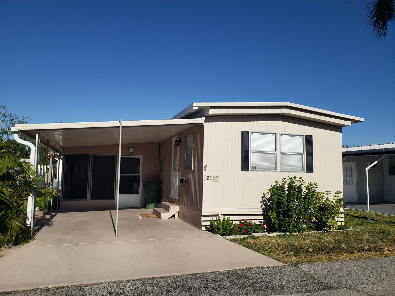 This quaint one bedroom home is perfect for a snow bird or year round resident. Home has brand new central A/C, new flooring, new washer & Dryer and more. this is a must see! The built in closet and drawers in the bedroom offer storage. the hallway to the bath is extended perfect nook for a small desk or room to move. The screened in lanai has more shelving for storage and houses the new washer & dryer. Washer and dryer and the remaing furniture are negotiable. You could easily enclose this space for additional living area. New pavers extend the parking area or great for a patio set to enjoy the evenings and happy hour with your neighbors! Bradenton Tropical Palms is a highly sough after community with its Low HOA fee. The park is fully gated and has a large heated pool, clubhouse with 4 indoor pickle ball courts, gourmet kitchen, stage area, bingo hall, fitness center, library, game room and so much more.