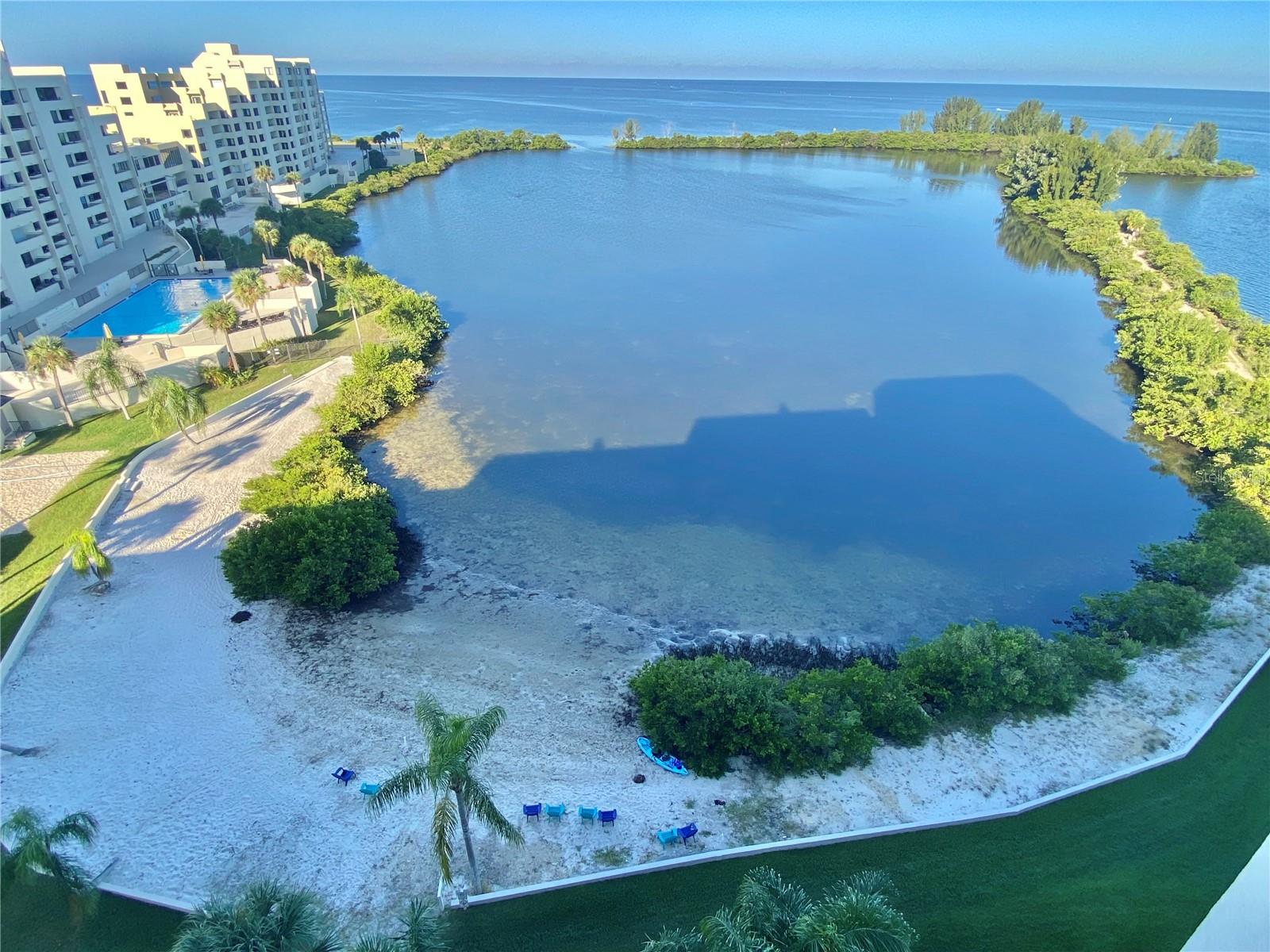 RARE OPPORUNTIY to rent top floor condo with Awesome Gulf of Mexico waterfront , Sunset & Sunrise views and relaxing Gulf breezes. Condo totally updated and upgraded and being offered furnished with all the contents and features new kitchen with light colored cabinetry, gorgeous granite counters, and stainless steel appliances. Open floor plan offers water views through the 8 foot sliding glass door from the kitchen , through the dining area, and the living room. The master suite also boasts awesome water views through the second 8 foot slider. The master bath has double vanities and closets. The condo boasts an additional bonus room that can be used as s den/office, dining room, or guest room. This Gulf of Mexico "get-a-way" is beautifully accented and decored with Sea Side theme. Watch the dolphin play, the manatee float and the water fowl soar while relaxing on your private covered balcony, private sandy beach or in the heated Gulf side pool . Offered with in unit washer and dryer and under building assigned parking space. This island is completely surrounded by water except for the 24/7 guarded entry for your upmost security. Fishing ,boating, & kayaking are all at your doorstep along with tennis & pickleball courts. Rental includes everything, even wifi. Community ideally located close to multiple beaches, restaurants, shops ,golf courses, to the SunWest Water Park and to all that the Tampa Bay and the St.Pete / Clearwater areas have to offer day or night. View the community tour to fly over or walk around the community. Call today for a private in person viewing or a virtual tour and Enjoy this Resort style Florida waterfront Life.! Don't you Deserve it! Rates vary depending on time of year and length of stay.