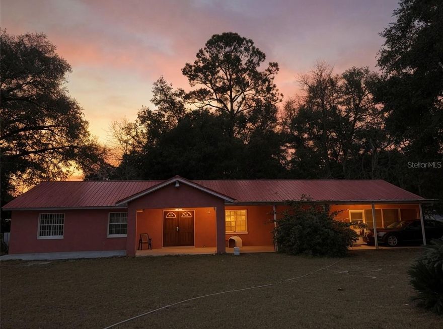 Discover peaceful rural living on this desirable corner lot in Silver Springs. This well-maintained concrete block and stucco home sits on nearly a fifth of an acre and comes with the peace of mind of a brand-new metal roof installed in 2024.
The heart of this home is its incredible entertainment potential. A generous 21x30 enclosed Florida room with a built-in bar creates the perfect space for hosting friends and family year-round. Step outside to find not one, not two, but three covered patios—ideal for morning coffee, evening relaxation, or simply taking in the quiet surroundings.
Inside, you'll appreciate the spacious kitchen designed for those who love to cook, along with easy-care flooring throughout (no carpet!). Unwind after a long day in the luxurious jacuzzi tub. The fenced yard provides security and freedom.
Parking is never a concern with a massive 13x58 attached carport offering covered space for multiple vehicles, boats, or toys.