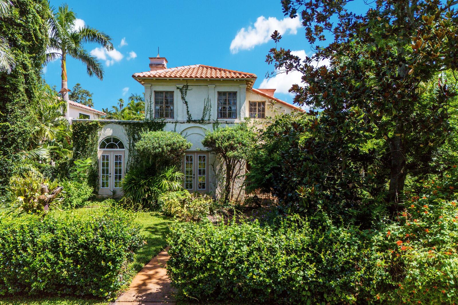 One of a distinguished pair of twin Mediterranean Revival estates, this residence is a rare surviving work of acclaimed architect Clarence C. Hosmer, recognized for his enduring contributions to Sarasota’s architectural heritage. Built during the exuberant Florida Land Boom of the 1920s, the home reflects the elegance and ambition of its era with grand arches, barrel-tile roofing, and intricate period details. The home’s story is as captivating as its architecture. The original owner moved in social circles with John and Charles Ringling, and at one point, the property itself belonged to Charles Ringling’s wife, Edith, a formidable figure in her own right who was directly involved in the management of the Ringling Bros. circus. Set on a coveted double lot in Sapphire Shores, a neighborhood originally planned with the mandate that all homes be Mediterranean or Italian in style, this estate offers a once-in-a-lifetime opportunity for visionary restoration. Behind its storied façade lies the chance to revive a masterpiece, blending its historic soul with modern luxury. This prime location is surrounded by Sarasota’s most treasured cultural institutions, including the Ringling Museum of Art, Ca’ d’ Zan and the Asolo Repertory Theater, and lies just two miles north of downtown. A short drive over the Ringling Bridge leads to the pristine beaches of Lido and Longboat Key.