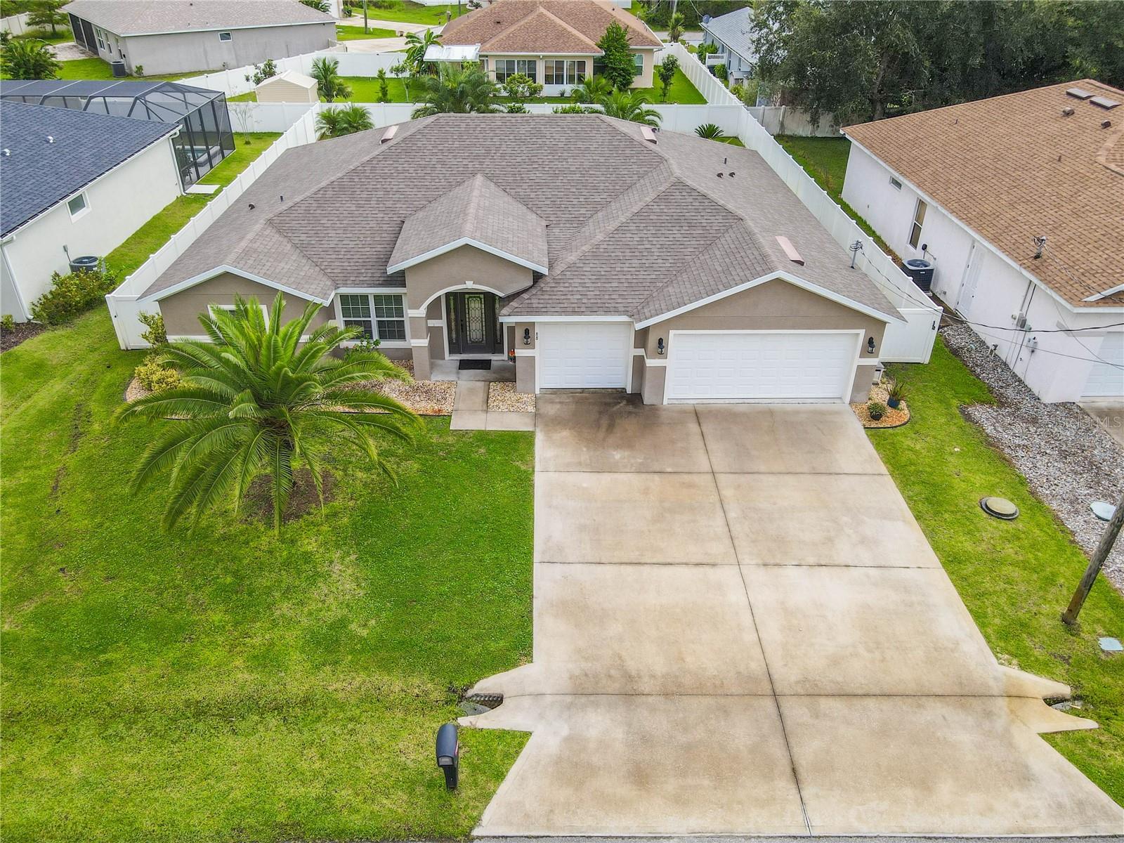 Your tropical dreams can now become your reality! Lovely Home in the city of Palm Coast (Almost New). Built in 2020 four bedrooms, two baths, and three car garage - (Augusta) floor plan from Seagate homes-. This home features a gourmet-inspired kitchen with 42' cabinets, staggered installation, crown molding and flush island quartz countertops. The split plan offers a private primary suite, highlighted architectural ceiling detail, and features two walk-in closets. Primary bathroom with dual undermount sinks set in an expanded vanity and large walk-in shower. Oasis style oversized screened lanai with aboveground extra-large spa. Enjoy the fully fenced backyard and much more. Located in Matanzas Wood neighborhood, it offers easy access to schools, shopping, banks, and other amenities. Easy access to Route 1 and I-95. Short ride to the ocean and beaches. YOU MUST SEE. NO HOA! Schedule your showing today!