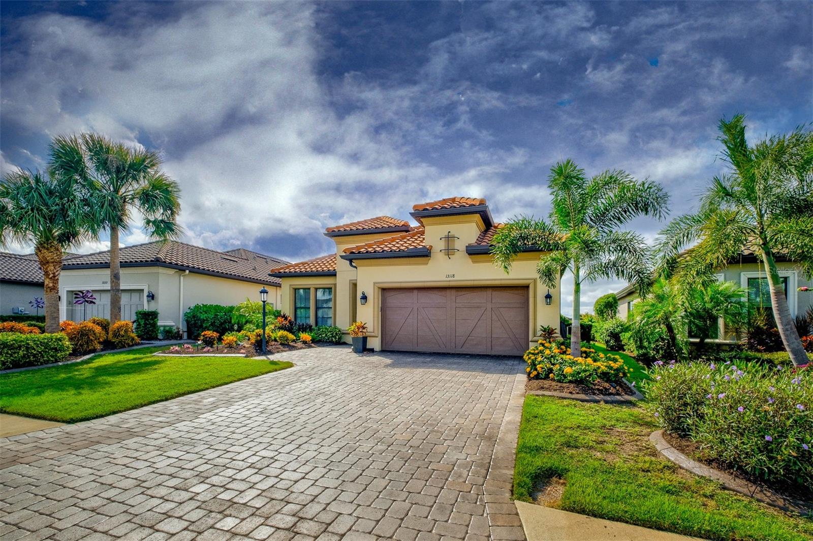 If you're looking for a true resort lifestyle that includes golf, tennis, two fitness centers, a resort style pool, culinary center, wellness center, tennis courts, pickle-ball courts, two dog parks, tiki bar, and a full-time lifestyle director, then look no further. This home features 3 bedrooms, 3 full baths, and a large den with custom barn doors for added privacy. When entering this home, you will notice the extended driveway and walkway to the front glass door. Upon entry, you will be greeted by an open and airy floor plan, featuring high ceilings and plenty of natural light. The extended gourmet kitchen is a chef’s dream that includes: upgraded cabinets with under-cabinet lighting, granite countertops, stainless steel appliances with a gas stovetop, and a newly installed oversized quartz sink. The spacious living room is perfect for entertaining guests or enjoying quiet nights in. The primary suite is a true retreat, offering a luxurious en-suite bathroom with dual sinks and an oversized walk-in spa-like shower. The walk-in master closet includes a newly installed custom closet for maximum organization. The two additional bedrooms are generously sized, both with well-appointed bathrooms and newly installed custom closets. The extended lanai (South facing) offers extended living area, saltwater pool and built-n-spa with gas heat, along with an outdoor kitchen with granite countertops. Pool cage includes customized colored lighting. Right outside the lanai is the beautifully landscaped backyard, where you can enjoy both lake and golf views. The oversized two-car garage includes a 4 foot extension, overhead storage unit, and an epoxy floor.
This home is on a beautiful lot with views of the 9th hole of the golf course. It includes a full deeded golf membership included in your HOA fees. Landscape care and maintenance are also included in this community
