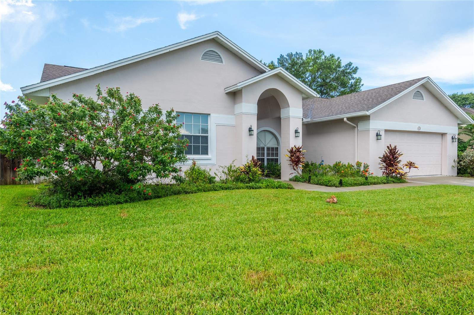 Beautiful Carrollwood Village subdivision (Stonegate) is the location of this lovely ONE STORY 4br/2.5 bath OR 3 bedroom PLUS office w/ closet. All floors in the entire home are tile… no carpet. Kitchen boasts stainless appliances, snack bar, built-in desk, island, and eat-in area. Located on almost the end of a cul-de-sac so no through traffic. Yard is fenced all around by neighbors’ fences. Several sets of sliders and French doors lead to screened lanai with 2 ceiling fans, overlooking beautiful back yard. Master bedroom features 2 closets one of which is walk-in, and ceiling fan. Master bath has 2 sinks, separate shower and garden tub. Extras with this home are: AC NEW IN 2023, high ceilings, in-ground sprinkler system, RECLAIMED water, pull down stairs to attic and garage door opener (cabinets and shelves in garage can convey), water softener, inside utility including cabinets and washer and dryer, and even an outside shower head with little doggie shower head also. NO CDD and low HOA ($671/yr). Conveniently located near major roads, shopping, hospitals, restaurants, etc. Even a local Cultural Center for shows, plays, events. The 21 acre Carrollwood Park contains tennis and pickleball courts, walking trails, dog park, soccer field and so many more fun things for everyone.