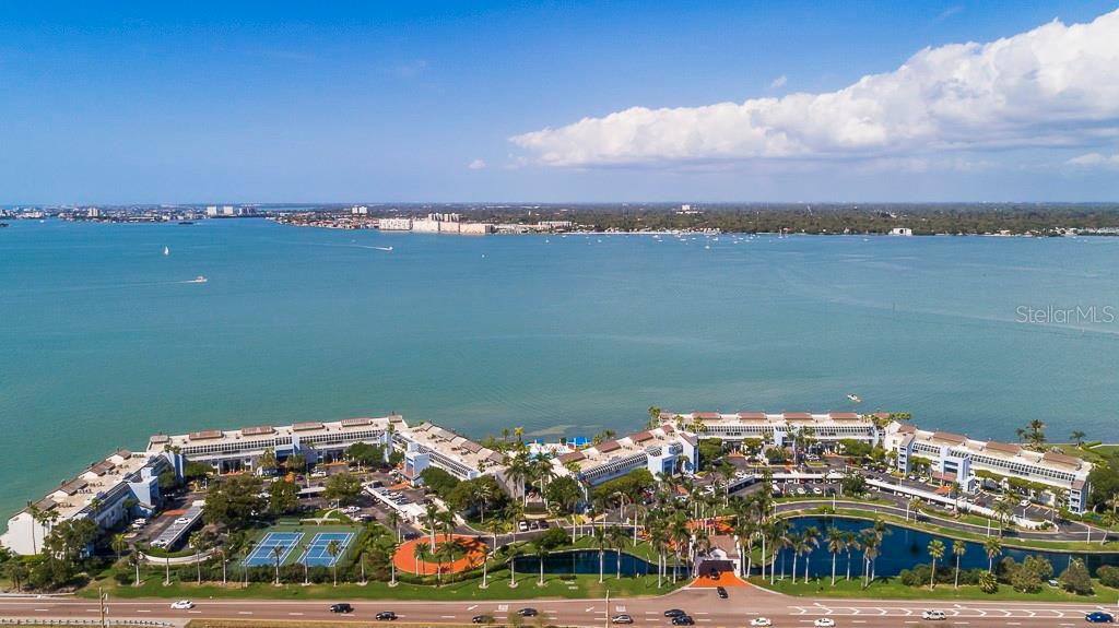 Welcome Home to paradise at Isla Key! A Waterfront community with panoramic views of Boca Ciega Bay. This desirable first floor condo is ready for your design and vision to create dream living space in the sought after Isla Key Community. Brand new 2024 large outdoor deck allows you endless days of sitting, grilling and soaking up the sun while taking in the breathtaking views of Boca Ciega Bay and sunsets. This 2-bedroom, 2-bathroom unit has an office/den which could be used as a 3rd bedroom when having guests. The split bedroom floor plan with the primary bedroom offers incredible views of Boca Ciega Bay. The kitchen flows to the oversized living/dining room, offering spectacular views of the bay and pool area. Amenities include the islands largest tropical landscape geo-thermal pool, hot tub, grilling area, pickleball, tennis and bocce ball. Monthly fee includes water, sewer, trash, internet, cable, exterior maintenance, landscaping, security, management and so much more. One pet is allowed, up to 20lbs. Designated storage closet at the front door and one reserved covered parking space included. Nearby Isla del Sol Yacht and Country Club (private memberships available) with 18 hole championship golf course and marina. Easy access and minutes to Gulf Beaches such as St Pete Beach, Fort de Soto Park, Pass-A-Grille. Easy access to the interstate and only 10 minutes to downtown St Petersburg with countless shops, cafes, restaurants, theaters, nightlife and the world-famous Dali Museum! Condo didn't experience any damage from recent hurricanes.