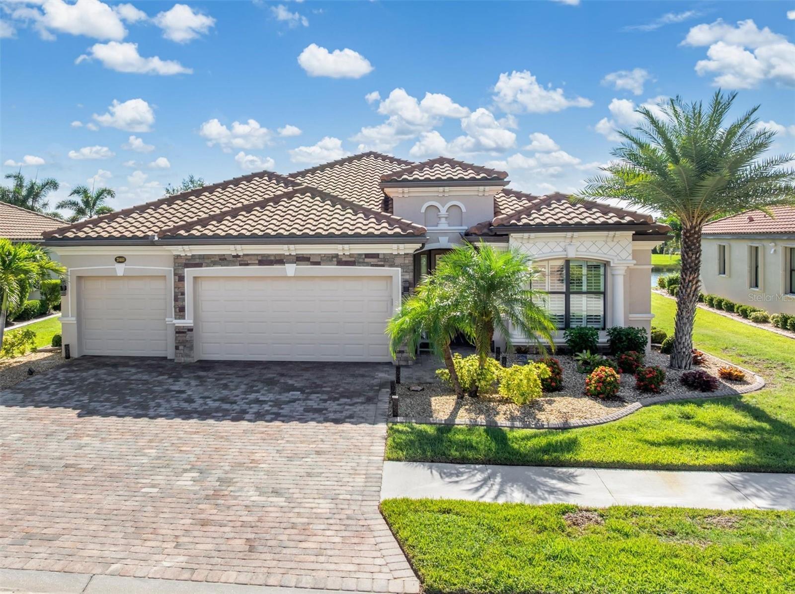 EVERY DAY WILL FEEL LIKE A VACATION IN THIS AMAZING HOME! Experience the best of Florida living in this spacious and impeccably maintained 4-bedroom, 2-bath home with a 3-car garage in the highly desirable, GUARD-GATED community of GRAN PARADISO at WELLEN PARK. Built in 2016 and located in an X FLOOD ZONE (per LOMR), this property offers peace of mind and resort-style amenities in a top-rated school district.
From the curb, the home makes a lasting impression with its tile roof, stacked stone accents, lush enhanced landscaping, and a wide paver driveway that provides ample parking for family and guests.
Step into your private backyard oasis featuring a custom Indigo-designed SALTWATER POOL with CLEARVIEW screening for uninterrupted lake views. The pavered patio and pool deck offer multiple areas for lounging and dining, while the NEBULA STARLIGHT LIGHTING in the lanai ceiling creates a magical evening ambiance. Whole-house gutters with buried drains and a freshly painted exterior (2023) ensure lasting curb appeal.
Inside, the home has been upgraded to include PLANTATION SHUTTERS, COFFERED and TRAY ceilings, accent wall and decorative trim in the primary bedroom, custom ceiling fans and tile flooring in living areas.
The OPEN FLOORPLAN is filled with natural light and offers beautiful pool and lake views from the main living areas. A formal dining room provides a welcoming space for entertaining while the dinette, next to the kitchen, is ideal for casual meals and everyday dining. The spacious FAMILY ROOM flows seamlessly into the kitchen, which features granite countertops, a custom backsplash, upgraded stainless steel appliances (including a newer dishwasher and refrigerator) and a functional design perfect for both everyday living and entertaining.
Recent improvements include a NEW AC (2022) with transferable 10-year warranty and additional attic insulation (2023) for energy efficiency and reduced utility bills. The laundry features a newer washer and dryer which will be left for Buyer’s convenience. The home features a 3-way split to the 4 bedrooms, one of which is currently used as an OFFICE/DEN. With plenty of storage capacity, this home offers flexible use for year-round or part-time occupancy.
Living in Gran Paradiso means enjoying multiple lifestyle amenities within this highly desirable GUARD-GATED RESORT COMMUNITY, located within the master planned community of WELLEN PARK and the amenities include trails, tennis, pickleball, resort-style pool, hot tub, luxury clubhouse with card and billiard rooms, library, fitness center, steam rooms, sauna. The HOA fees include LAWN MOWING, full access to all amenities and a LIFESTYLE DIRECTOR to plan events and activities for the residents. Take your GOLF CART to the clubhouse to meet friends and enjoy the facilities! The community is ideally located, with easy access to I-75, downtown Venice and multiple sandy beaches on the Gulf. Within Wellen Park, there are restaurants, trails, baseball at the CoolToday stadium (Atlanta Braves spring training) and championship golf courses, as well as regular events (concerts, farmers market etc) and a vibrant Downtown area for you to enjoy. For families, the area features top-rated Sarasota County schools, including Pine View School for the Gifted (ranked #1 High School in Florida). DISCOVER GRAN PARADISO TODAY!