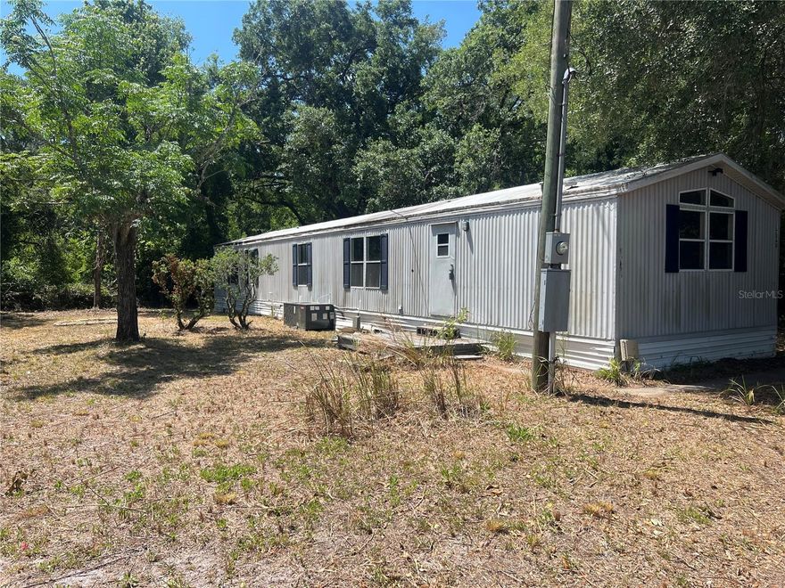 Nice Doublewide on Double Lot 70X110 The structure is in good shape. Situated on a paved quiet road. No neighbors on either side. Conveniently located close to shopping and SR 52 for easy access to Tampa International. PROPERTY HAS BEEN OFFICIALLY ALL CLEANED OUT AND YARD HAS BEEN CUT AND TREES TRIMMED.
