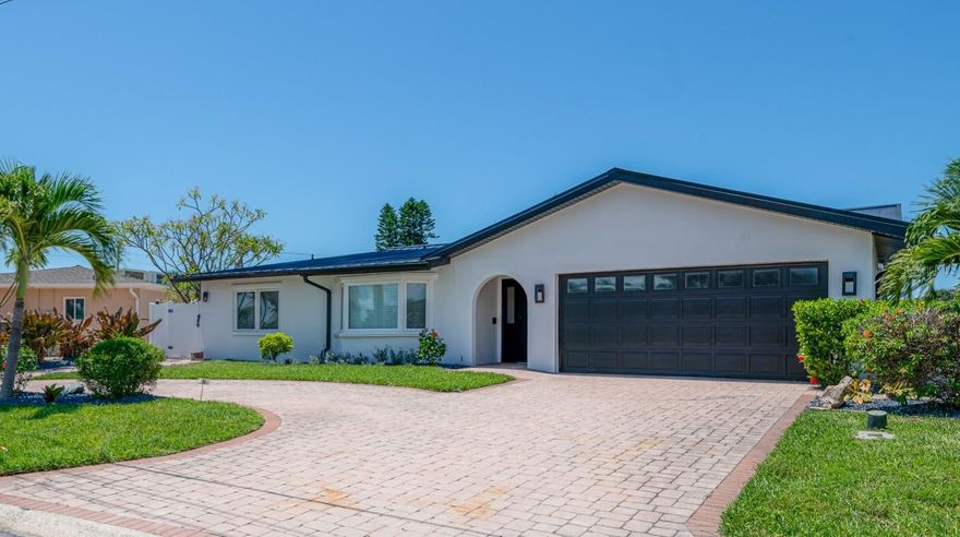 Looking for the perfect beach investment property or a beautiful home to call your own? This is your chance to own a turn-key waterfront retreat just a five-minute walk to one of the top-rated beaches in the country! This exceptional four-bedroom, three-bathroom executive home boasts a modern open floor plan with a split-bedroom design, including two spacious master suites. Upon entry, you’ll be greeted by abundant natural light and a bright, inviting atmosphere. Inside, you’ll find brand-new kitchen and bathroom cabinetry, stainless steel appliances, fantasy brown granite countertops, and an apron sink — all designed for style and function. The living, dining, and kitchen areas flow seamlessly, making entertaining effortless, and the oversized island is perfect for casual gatherings or informal dinners. Enjoy beautiful views from the kitchen and dining area and primary bedroom, extending out to the pool and beyond to the saltwater canal.

The home has been thoughtfully updated throughout with new flooring in the secondary bedrooms, a new AC system, new water heater, and all-new pool equipment. The entire home has been completely rewired for modern efficiency and safety, and fresh landscaping adds to its curb appeal. The oversized master suite is a private retreat, complete with a sitting area, sliding doors to the pool and canal, a walk-in closet, and a beautifully updated en-suite bath. Step outside to enjoy your own Florida paradise featuring a large saltwater pool, sunny lounging areas, a relaxing pergola, and gorgeous water views. This home has also been a highly successful vacation rental, generating $134,000 in gross bookings in 2022, and can be sold fully furnished for a seamless transition — perfect for investors or those seeking a personal getaway. Nestled in the desirable Three Palm Point subdivision on a quiet dead-end street, this home offers the perfect combination of modern upgrades, investment potential, and a lifestyle that captures the very best of Florida living.