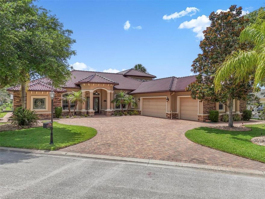 Waterfront Luxury in The Sanctuary — Protected Harbor; NO WAKE ZONE. This impressive 5-bedroom, 4-bath canal-front estate with boat cabana offers deep-water access just 6 residences off the Intracoastal Waterway, making it ideal for large boats and the ultimate Florida boating lifestyle. Designed for entertaining and everyday comfort, the home features soaring tray ceilings, pocket sliders framing beautiful canal views, a spacious eat in kitchen with granite countertops, travertine tile, stainless appliances, walk-in pantry, and a game room complete with a full bar.
The private primary suite offers a spa-inspired bath with a large walk-in shower, bidet, abundant storage, and a walk-in closet that doubles as a safe room. Upstairs, guests will enjoy two additional bedrooms, a full bath, a second living area, and a balcony overlooking the water.
Step outside to your resort-style lanai featuring a full outdoor kitchen with grill, smoker, and cooktop, plus a heated spa/splash pool surrounded by tropical landscaping. Boaters will appreciate the private dock with 16,000-lb lift and easy access to the Intracoastal. Additional highlights include a self-cleaning glazed tile roof imported from Portugal, whole-house generator, three newer HVAC systems, private irrigation well, and a high elevation with no flood history. Located within Palm Coast’s premier gated community, just minutes from shopping, dining, golf, and the beach.