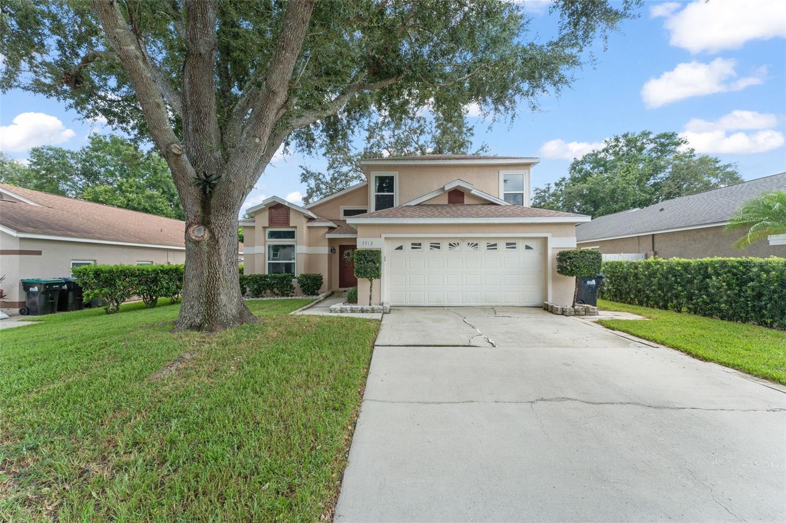 **This house comes with a REDUCED RATE through the seller's preferred lender. This is a lender-paid rate buydown that reduces the buyer's interest rate and monthly payment.** Welcome to this beautifully updated 4-bedroom, 2.5-bathroom home with nearly 2,200 sq ft of living space, offering a perfect blend of modern design and everyday comfort. Nestled on a manicured lot in a quiet Orlando neighborhood, this two-story gem also features a 2-car garage and a fully fenced backyard—ideal for both entertaining and relaxation. The inviting front yard, framed by lush landscaping and a mature shade tree, sets the tone as you enter. Inside, you’re greeted by soaring vaulted ceilings and a clear view of the home’s open-concept layout, giving the space an airy, welcoming feel. Just off the foyer, the chef’s kitchen awaits to the left—an entertainer's dream. It boasts cabinetry with crown molding, a shimmering pearl backsplash, stone countertops, a standalone range hood and cooktop, and a large island with breakfast bar seating. Stainless steel appliances, including a built-in oven and wine fridge, complete this elegant culinary space. Across the island, the formal dining area shines under a modern chandelier, while the living room features a cozy stone-lined fireplace and sliding glass doors that lead to your backyard retreat. A convenient half bathroom is located near the kitchen and living room for guests. The primary suite is thoughtfully located on the main floor, offering privacy and ease of access. With a large window overlooking the backyard, this peaceful retreat includes an ensuite bathroom with a dual-sink vanity, a floor-to-ceiling tiled walk-in shower, and a generous walk-in closet. Upstairs, a loft-style landing gives you a view over the main living space and leads to three spacious guest bedrooms, each with built-in closets and cozy carpeting. The second full bathroom, also upstairs, features a dual-sink vanity and a tiled shower for added convenience. Step outside and discover a backyard designed for versatility—one side offers a paver patio ideal for dining, lounging, or entertaining, while the other side features a grassy lawn shaded by a mature tree, perfect for play or quiet afternoons. 7712 Brookway St is the ideal home for anyone seeking style, space, and function—all in a central Orlando location. Don’t miss the opportunity to make it yours. Schedule your private showing today!