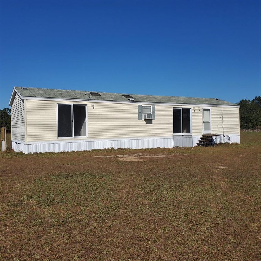 Peaceful and serene, perfectly square 10 acre parcel in country with 2 bedroom mobile home and HUGE metal building/workshop on slab with power. Land is fenced and cross fenced.  The mobile has little value as it is a fixer upper. Value is in the land.