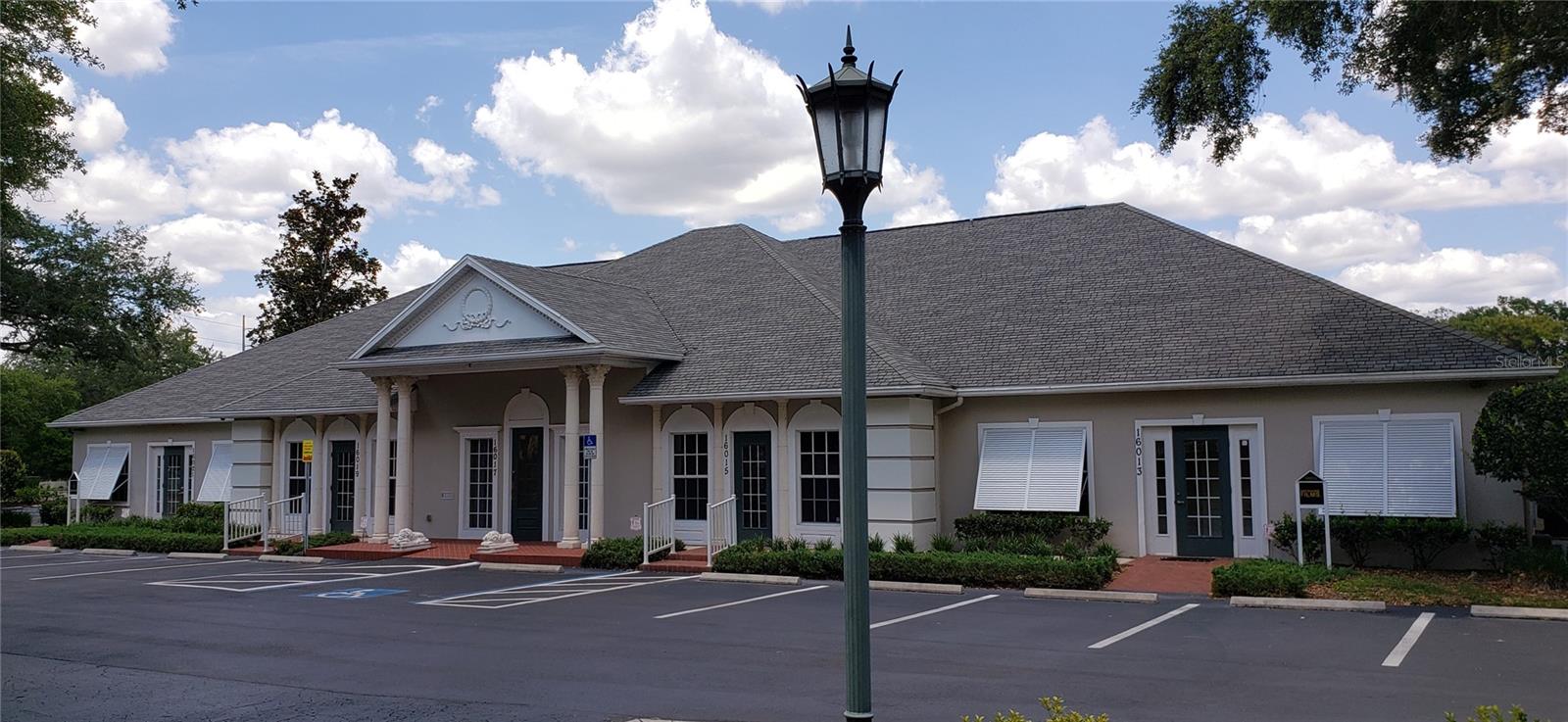 FULLY LEASED!! LUXURIOUS WATERFRONT OFFICE BUILDING. This desirable location features 400 feet frontage on busy US-41 in North Tampa. Perfect for a 1031 exchange. The building contains 5 waterfront tenant suites, each under 2,000 s.f. with separate utilities, street addresses and drive-up private entries. Silver oak porcelain tile and Benjamin Moore finishes create a notable welcome to all entry lobbies. Solid core interior doors with premium hardware throughout. The interior environment is controlled by programmable thermostat HVAC systems within a heavily insulated Icynene spray foam enclosed attic which keeps utility costs low. The Magnolia Center is a unique 4 building (all lakefront) park-like executive office center. The buildings feature timeless Southern architecture including premium designer shingles, hand-cast concrete Corinthian columns, herringbone brick walkways and abundant parking. Frontier (high-speed fiber optic internet), Spectrum and Level 3 Communications are also on site. Replacement costs for this high-quality attractive property certainly exceed the asking price! Conveniently located to I-275, Carrollwood, University of South Florida, Moffit Cancer Center, New Tampa, and the explosive growth of Pasco County (Lutz, Land O'Lakes, Wesley Chapel). This incredible location is all within a short distance (walk) to Avila, Publix and a new Starbucks! NO SIGN, PLEASE DO NOT CONTACT TENANTS.