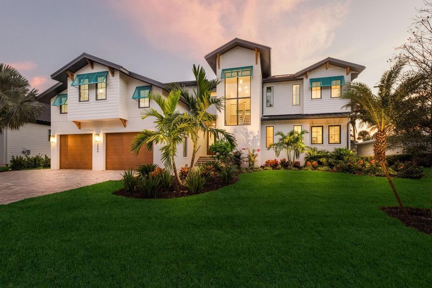 One or more photo(s) has been virtually staged. Welcome to a brand-new coastal masterpiece that redefines luxury living on world-renowned Siesta Key. Designed with both sophistication and comfort in mind, this waterfront retreat blends timeless architecture with modern amenities, all just moments from Siesta Village and the powdery sands of Siesta Beach. Inside, soaring ceilings and walls of glass bathe the home in natural light, while light wood floors bring warmth and elegance throughout. The heart of the home is a double-island chef’s kitchen, complete with premium appliances, custom cabinetry, and a generous walk-in pantry—perfect for both intimate family meals and grand entertaining. This residence offers four en suite bedrooms, including two primary suites (one upstairs and one downstairs), providing flexibility and privacy for family or guests. An additional private office and 600± SF of unfinished space above the garage present endless possibilities for customization. Seamlessly integrated indoor and outdoor living spaces create a true resort-style atmosphere. Step outside to enjoy multiple balconies, a pool and spa overlooking the water, a fully equipped outdoor kitchen, and a dedicated pool bath. For the boating enthusiast, this property features two boat lifts and quick access—just five minutes by water to the open bay. The location at the end of a quiet dead-end street ensures both serenity and privacy, with the added bonus of no homes directly across the canal, offering wide and peaceful views. This is more than a home; it’s a statement of waterfront luxury and the perfect canvas for your Siesta Key lifestyle. Days on market shows from pre construction.  Certificate of occupancy issued September 2025.